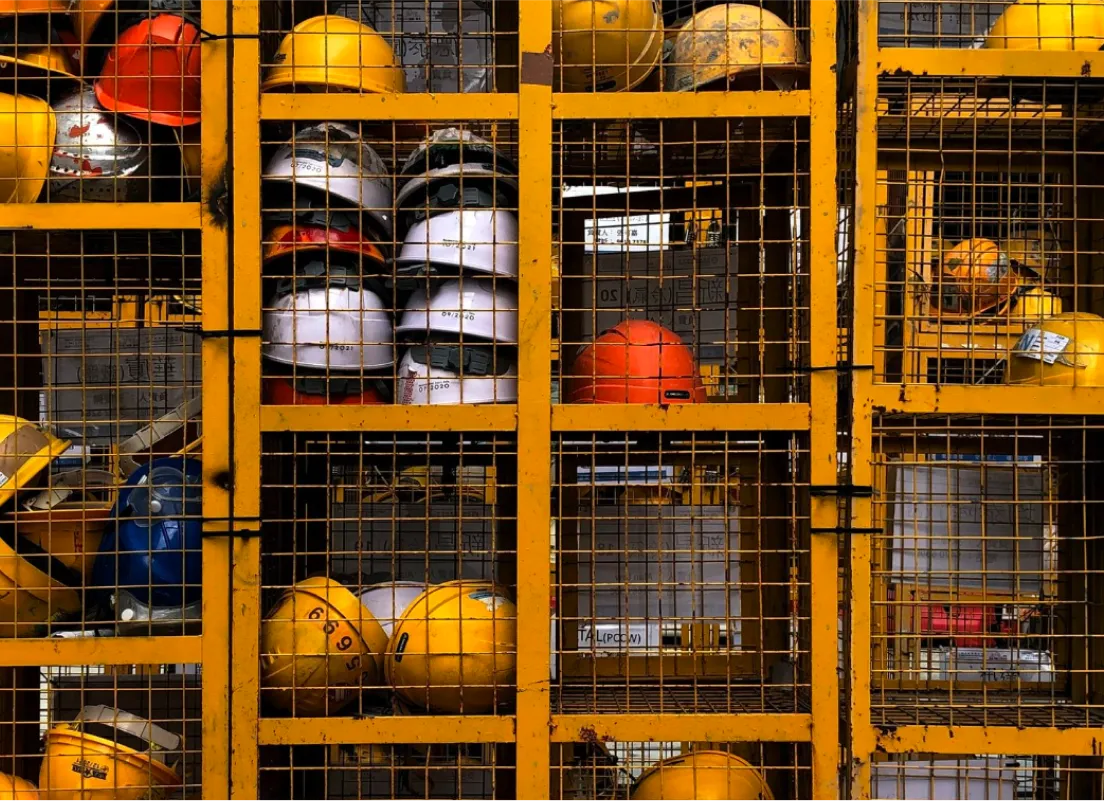 there are many helmets in the cage of a building