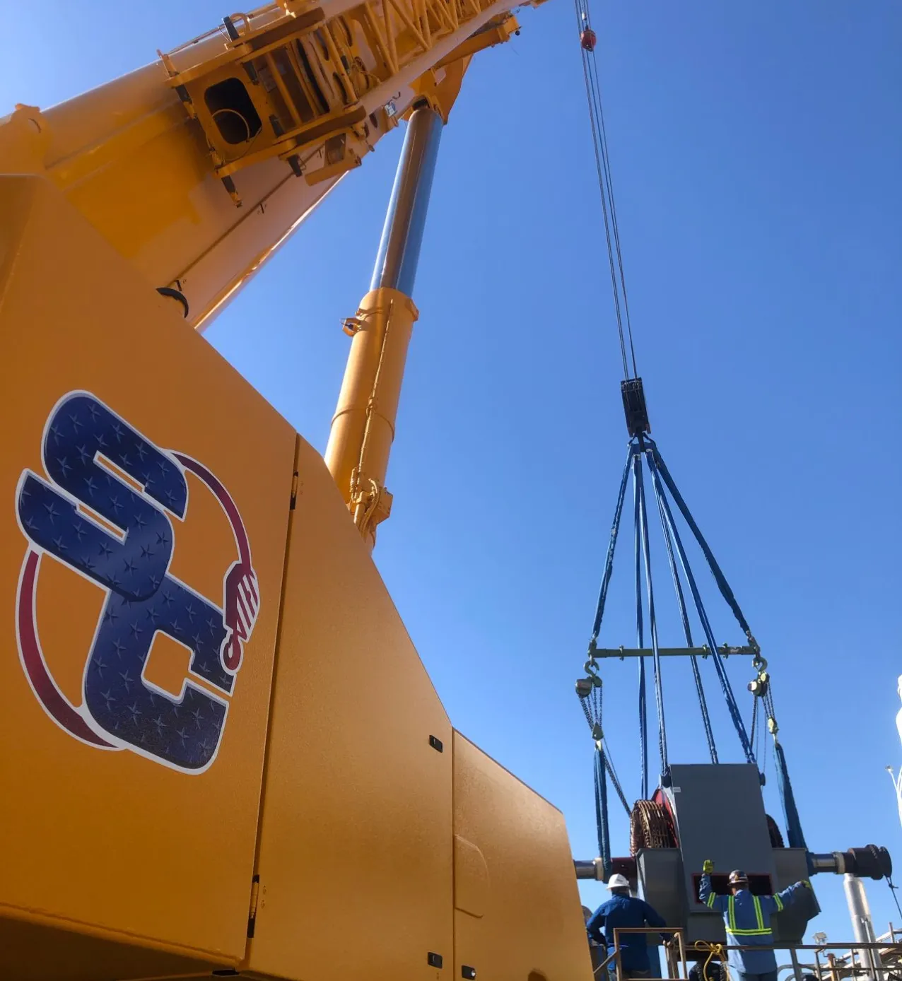 Image of a man working on a large crane. Sterling Crane