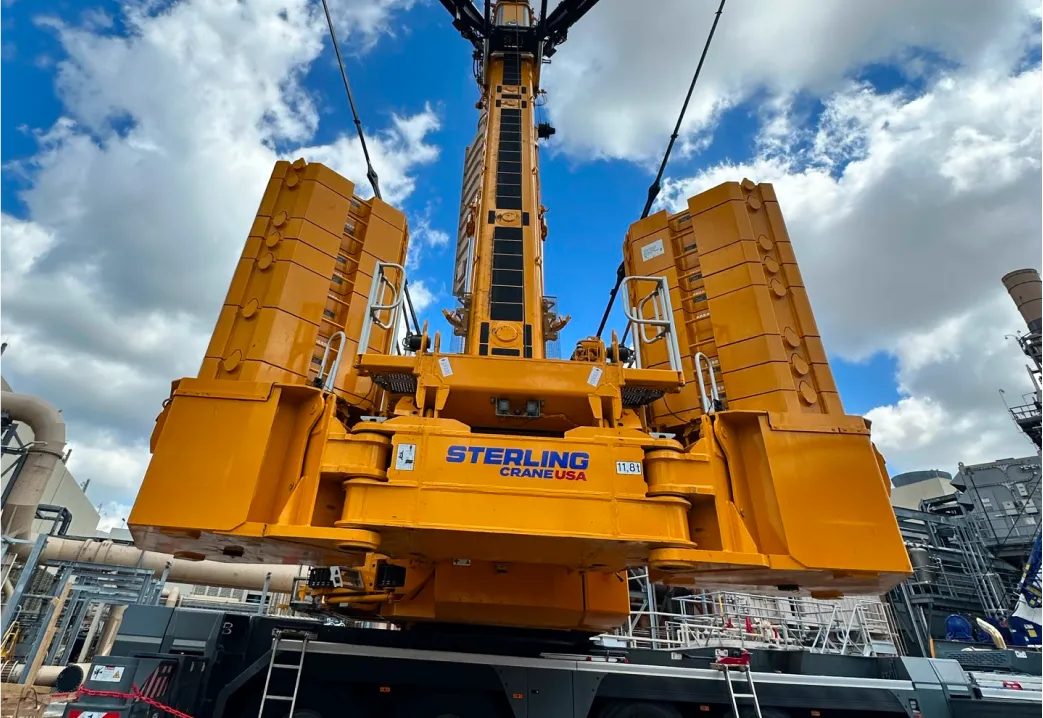 a close up of a crane on a truck with a sky background