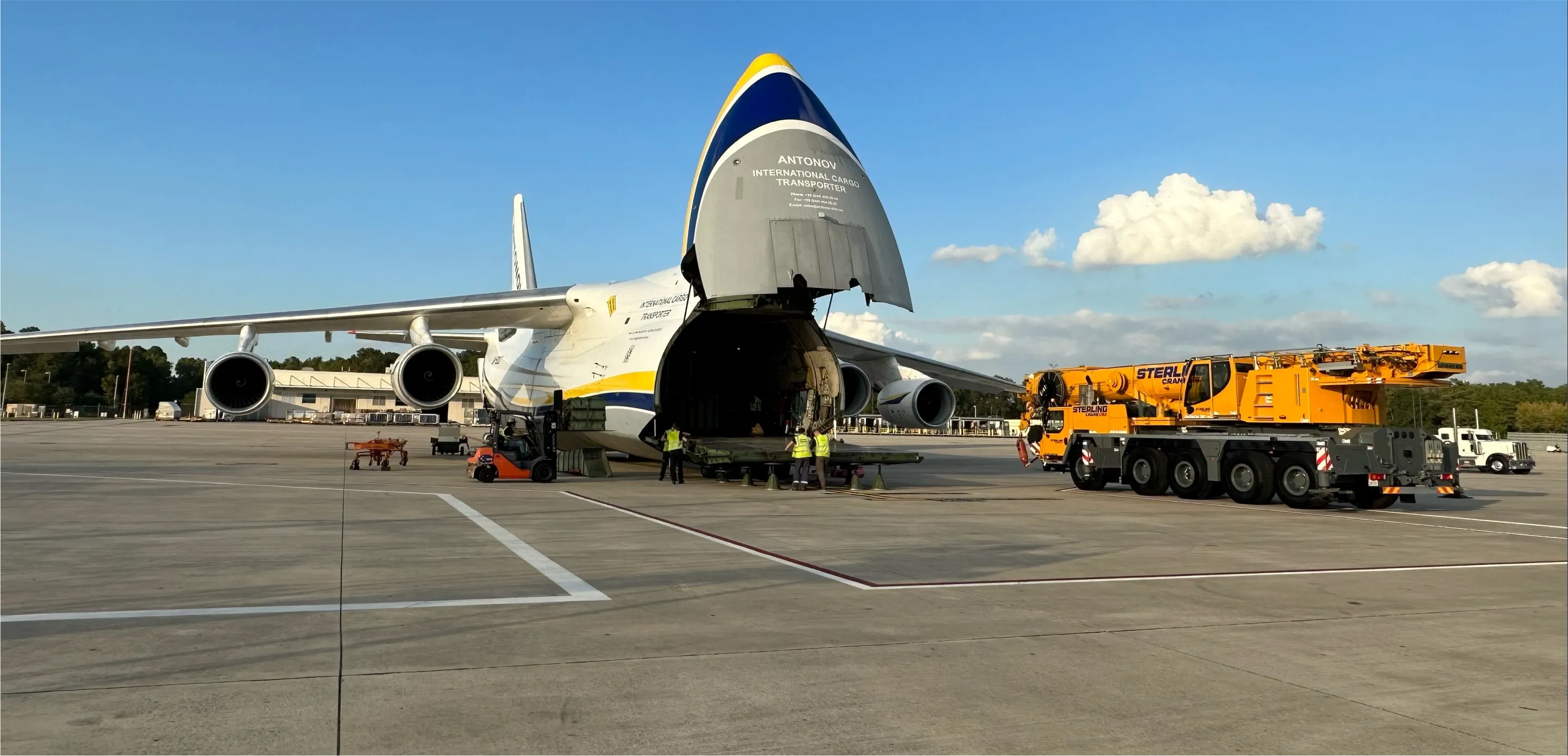 there is a large airplane that is being loaded with a crane