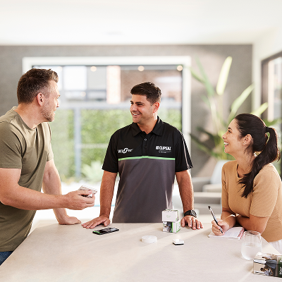 A Clipsal technician consulting with two homeowners about smart home products — click to join Club Clipsal.