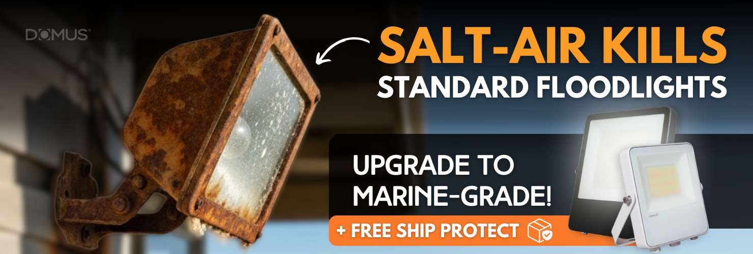 Ad showing a corroded floodlight next to two DOMUS marine-grade LED floodlights in black and white. Bold text reads “Salt-Air Kills Standard Floodlights – Upgrade to Marine-Grade!” with a 4.9-star business rating and “Shop Now” button.