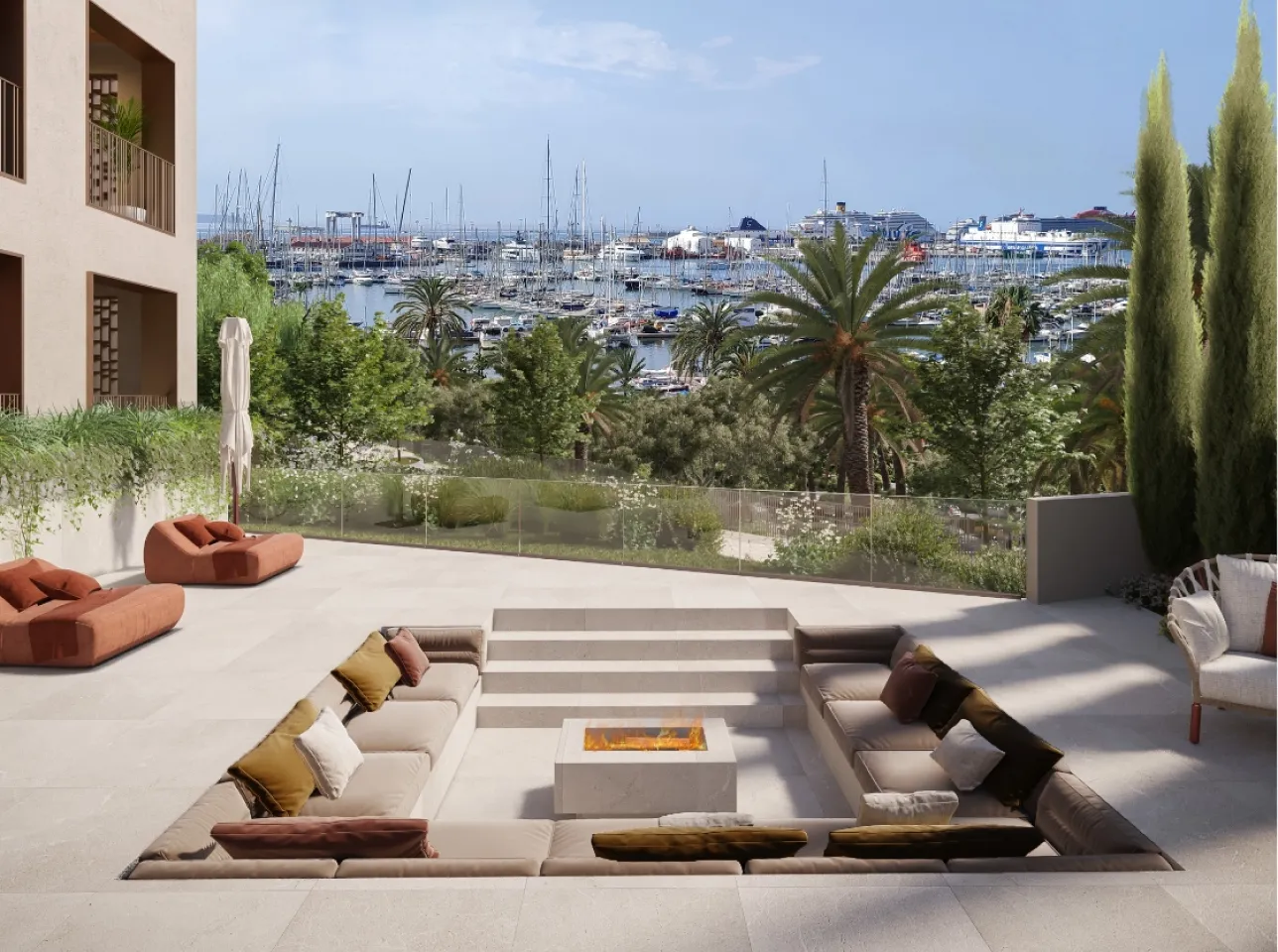 a patio with a fire pit and a view of a harbor and boats in the background