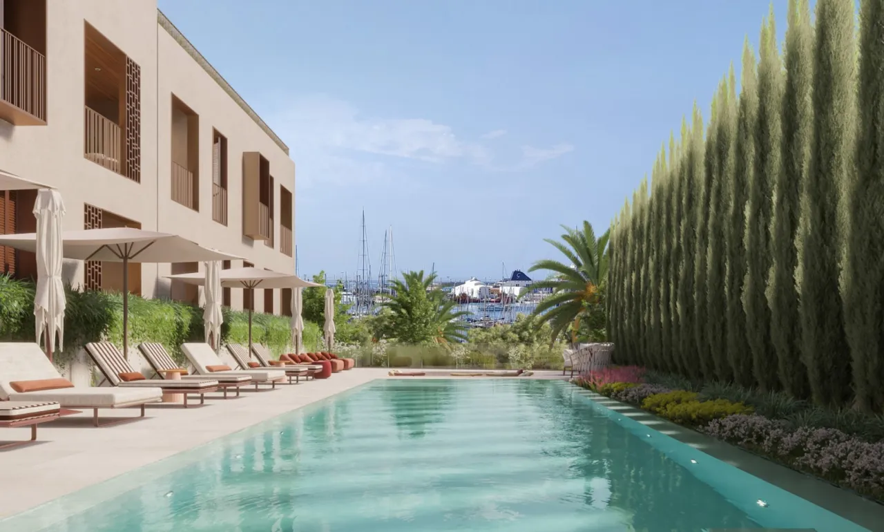 a pool with chairs and trees around it