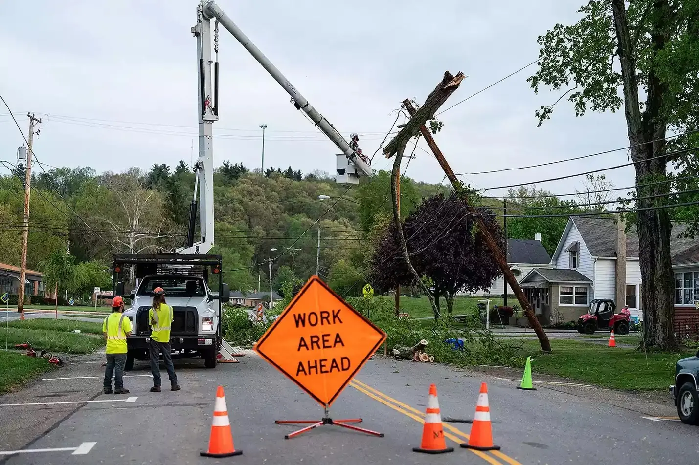 An Asplundh Tree Expert crew removes a tree from a power pole along Walnut Street just before Indian Valley High School in Gnadenhutten, Picture