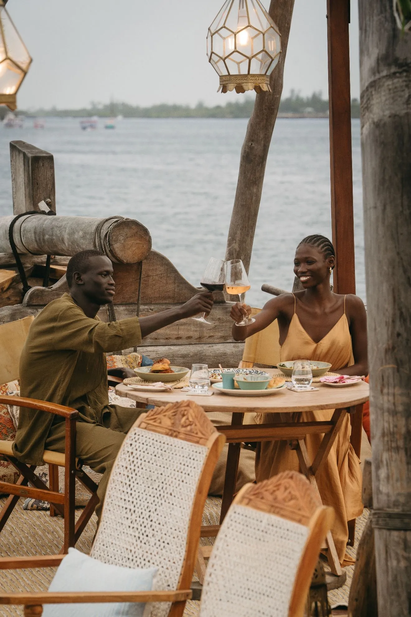 Guests raising a toast at dinner on the dhow above Mida Creek