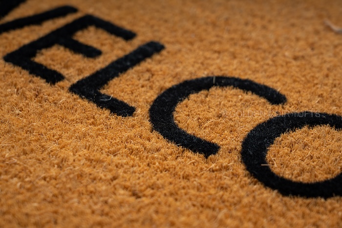 Flocked coir mat with a soft flocked surface over a coir base
