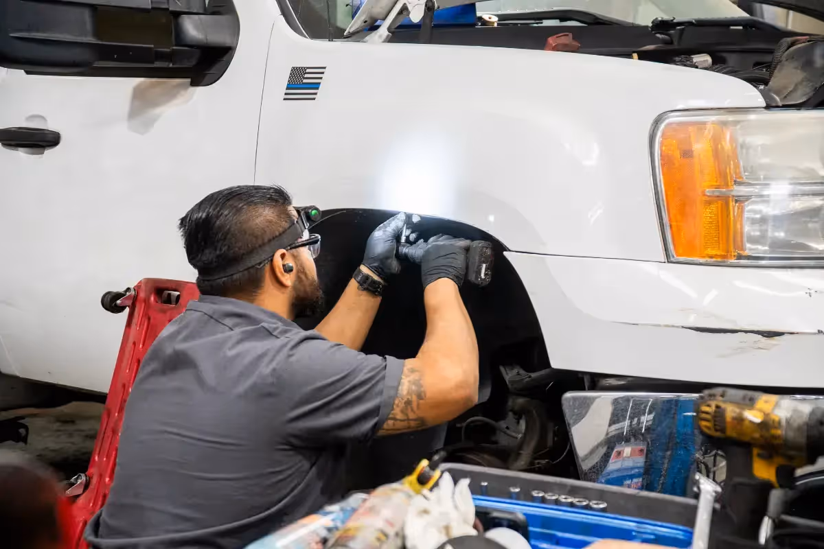 Diesel mechanic performing suspension repair services in Fontana, CA