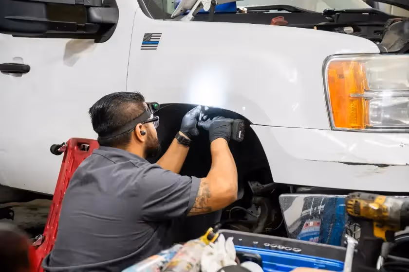 Diesel mechanic performing suspension repair services in Fontana, CA