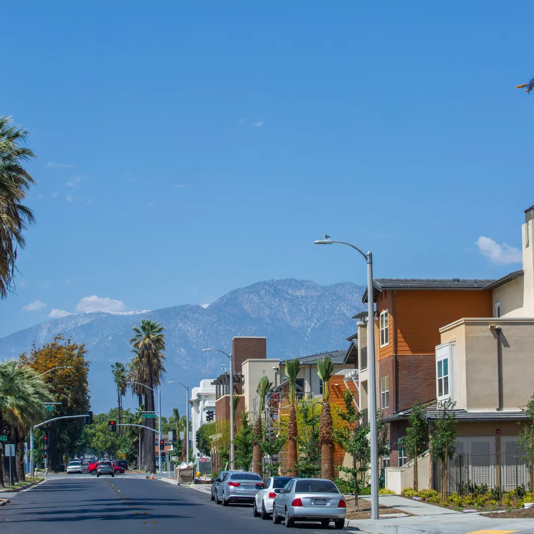 Southern California street with palm trees and mountains