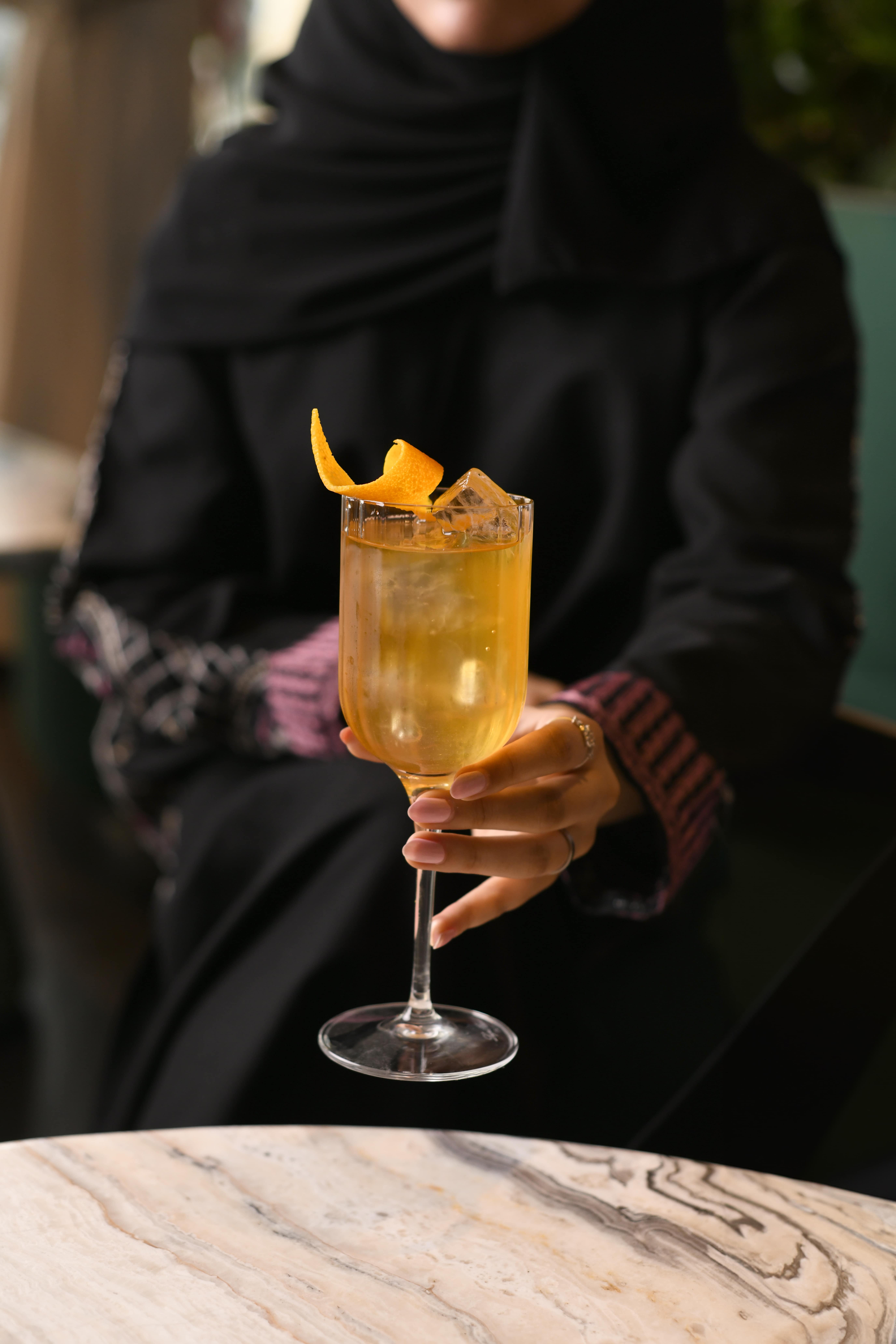 Close up of a bar tenders mixing a blue herbal drink