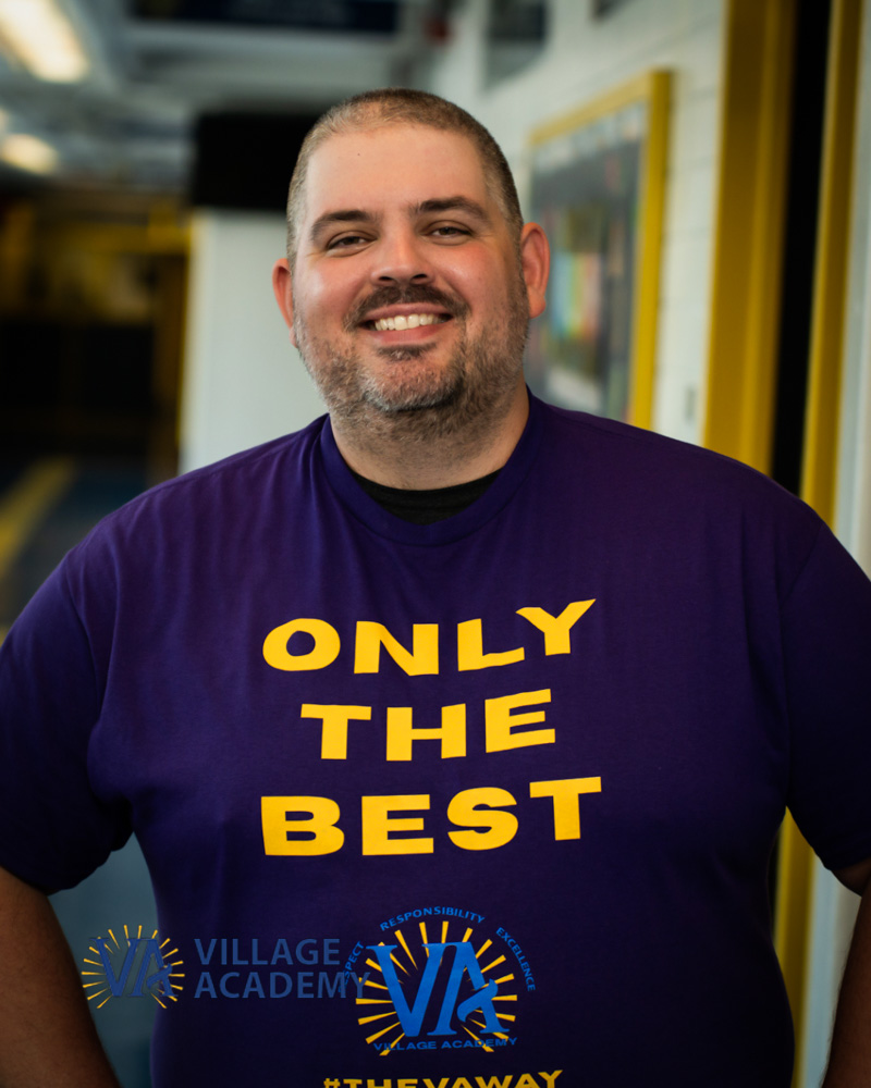 Mr. Sobolewski smiling in Village Academy Only The Best shirt