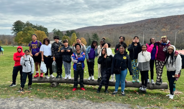 Students posing together outdoors during a fall field trip