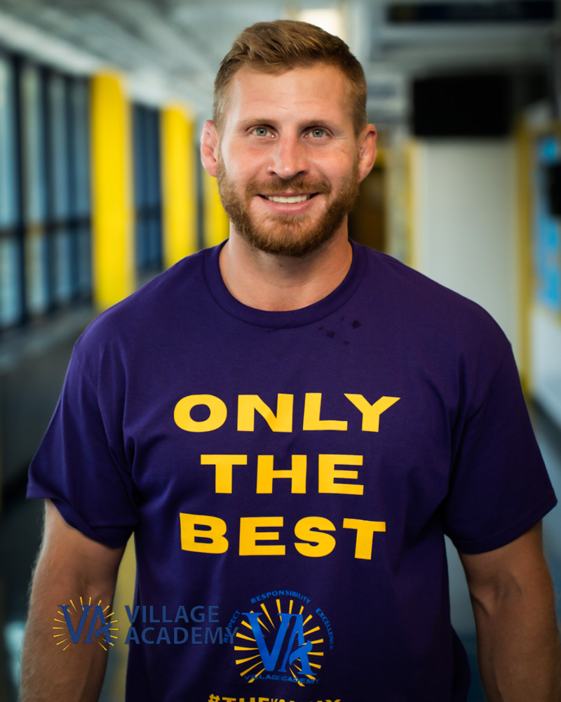 Mr. Wolfson smiling in a Village Academy Only The Best shirt