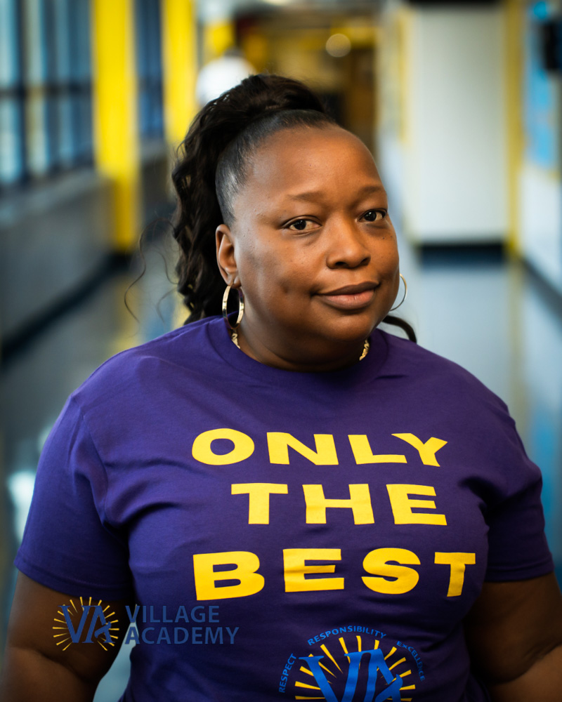 Ms J Hall Village Academy staff member in school hallway