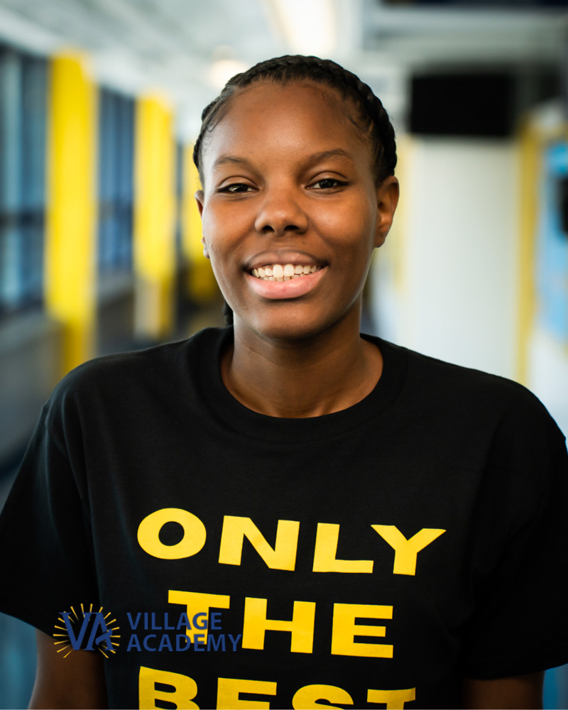 Smiling Village Academy staff member Ms. Hodges in school hallway