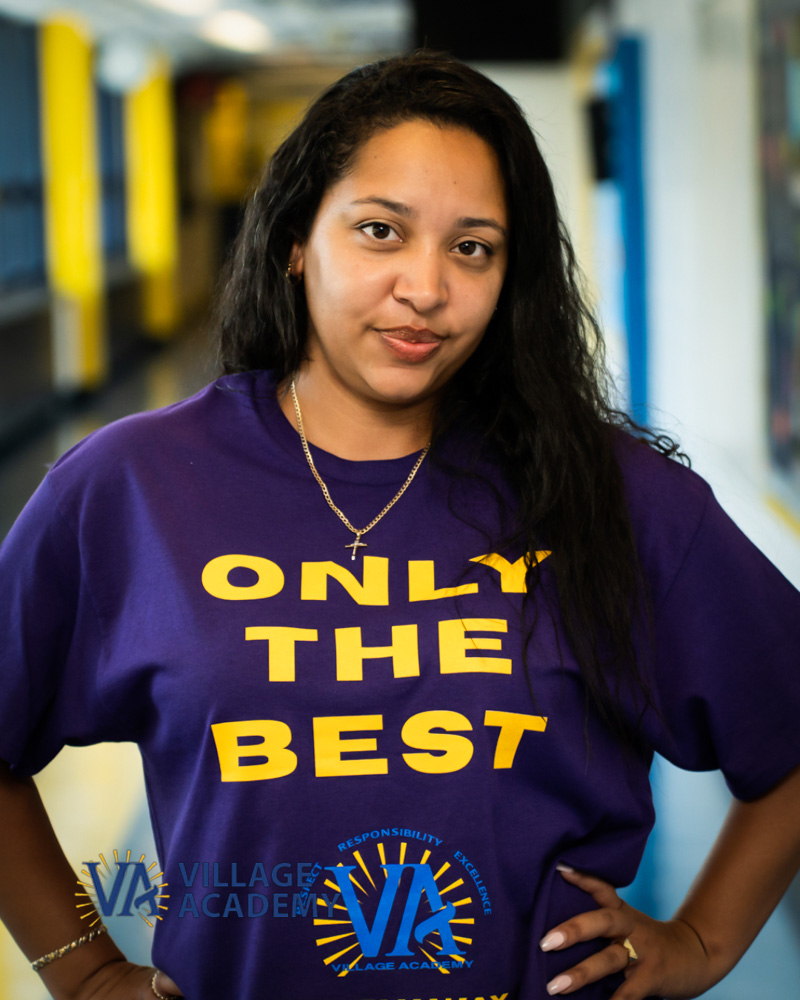Ms. Gomez staff member wearing Village Academy school shirt
