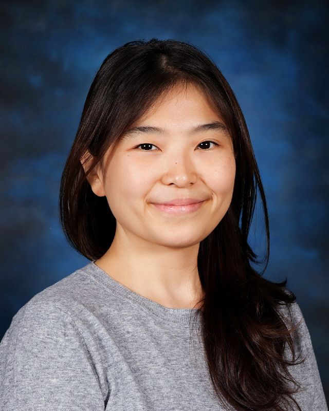 Ms. Shin smiling in a school staff directory photo