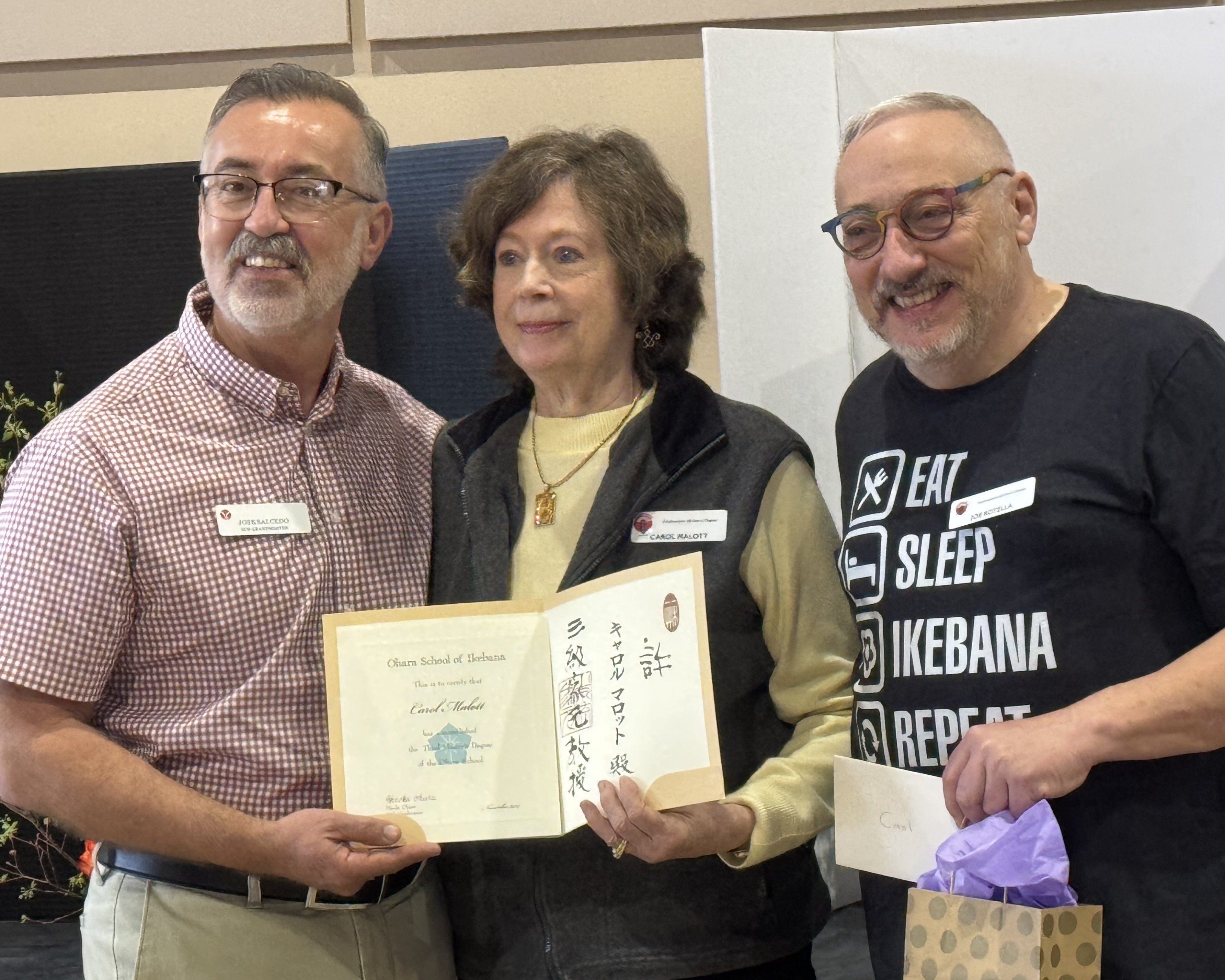 Carol Malott (center) receiving her Third Term Master certificate from sensei José Salcedo (left) and Joe Rotella (right) at the Southeastern Ohara Chapter conference in Greer, SC.