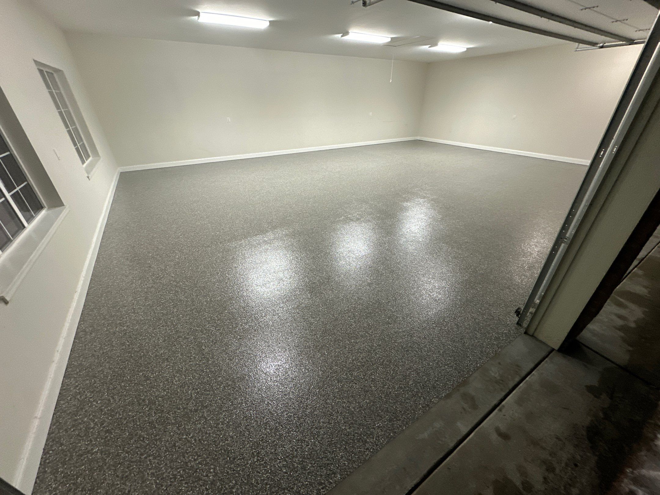 Silver Creek flake polyurea garage floor with white walls in a Woodinville home