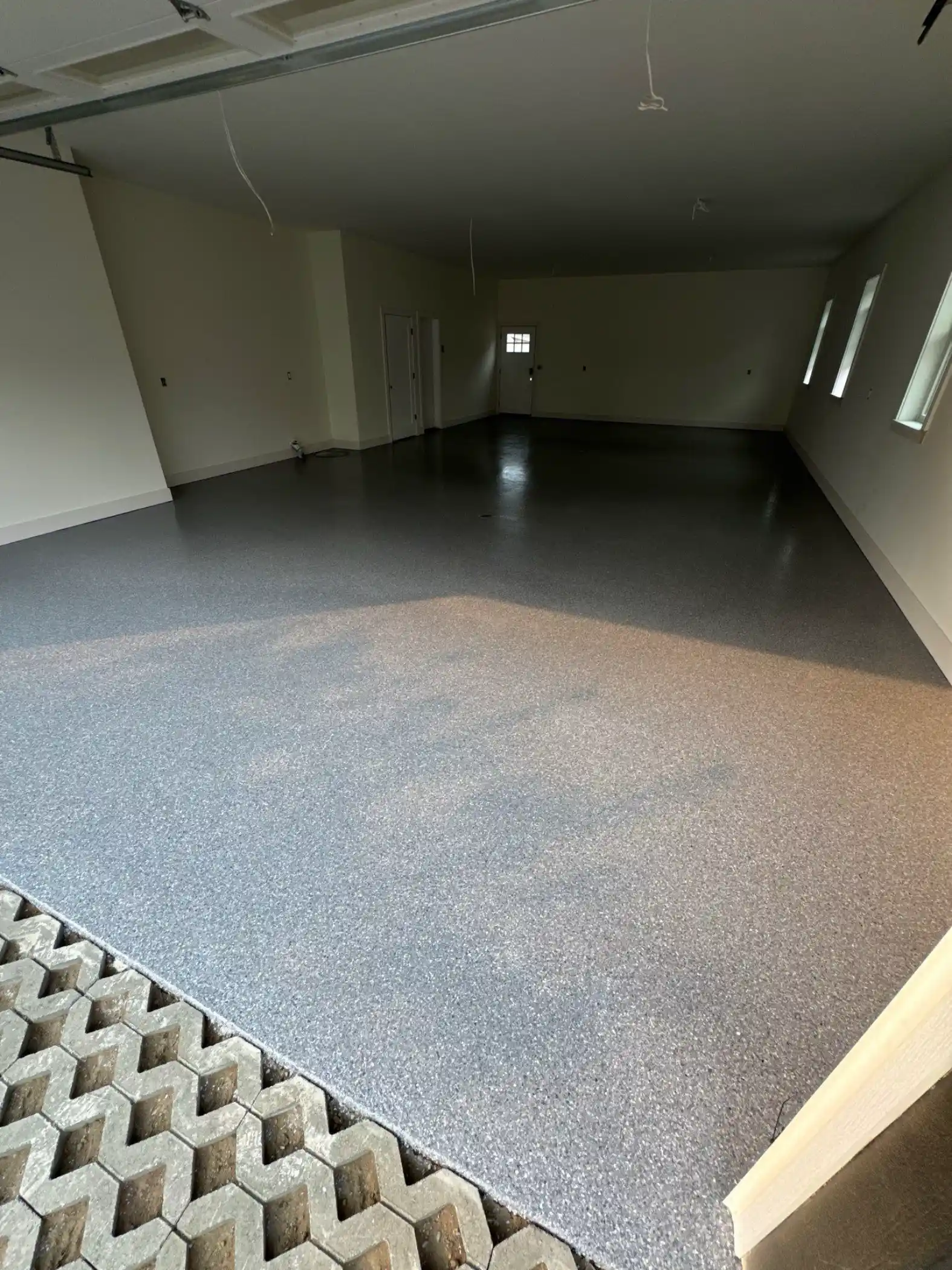 Long new-build garage in Fall City with a Granite flake polyurea floor
