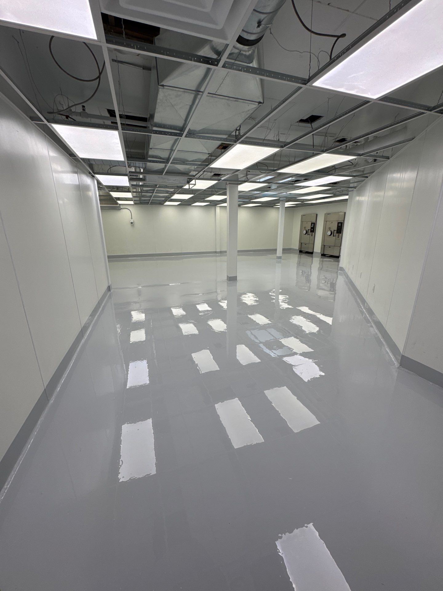 Solid Medium Grey polyurea floor in a long corridor at a Tacoma processing facility