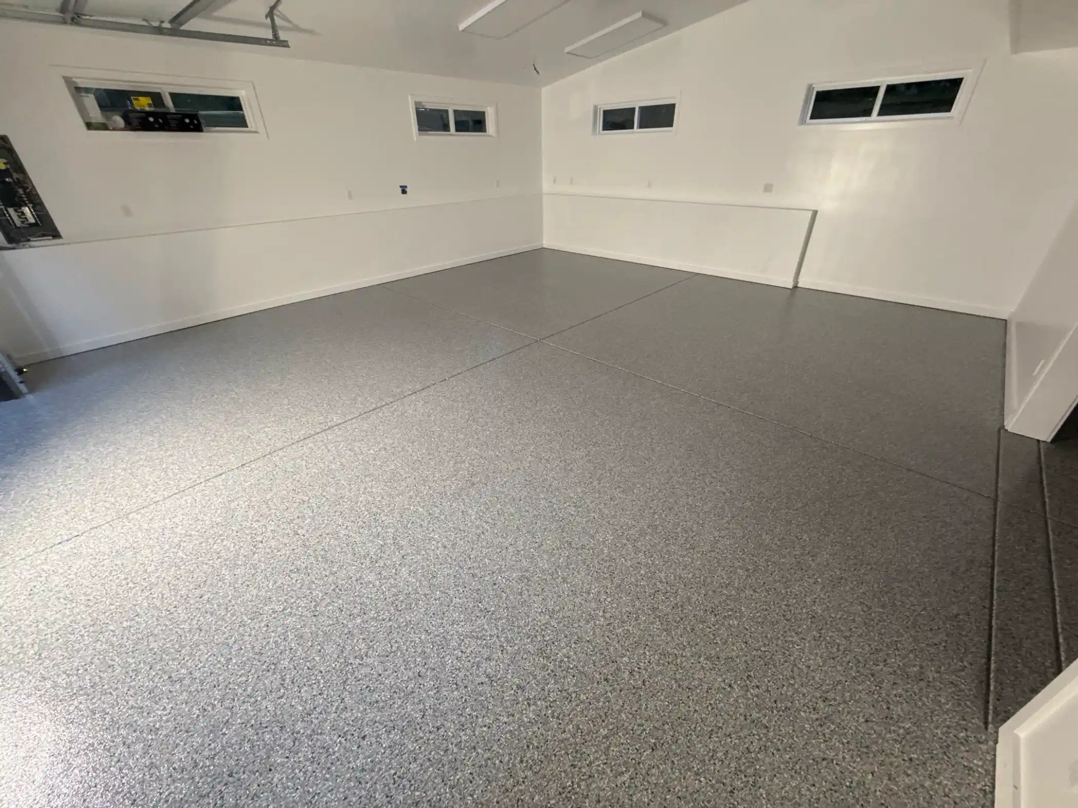Wide view of a white-walled Woodinville garage with Tidal Wave polyurea floor
