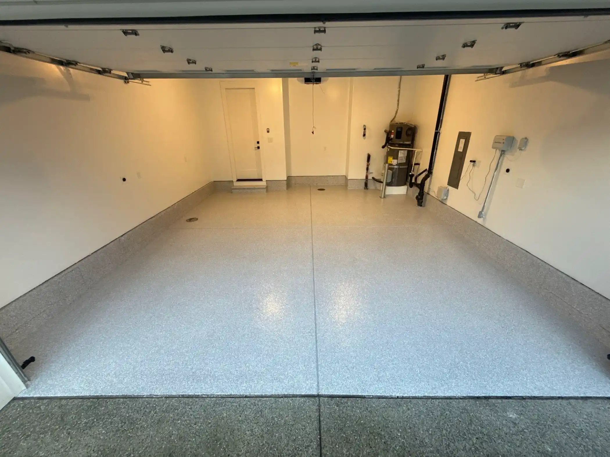 Two-car Duvall garage with a light Ash flake polyurea floor and coated stem walls