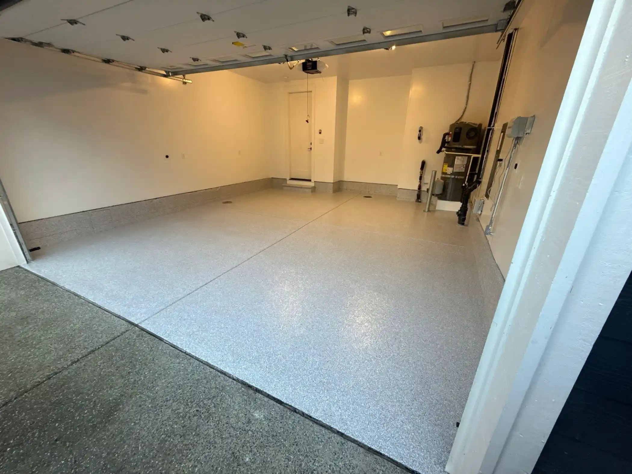 Ash flake polyurea garage floor seen from the open door of a Duvall home