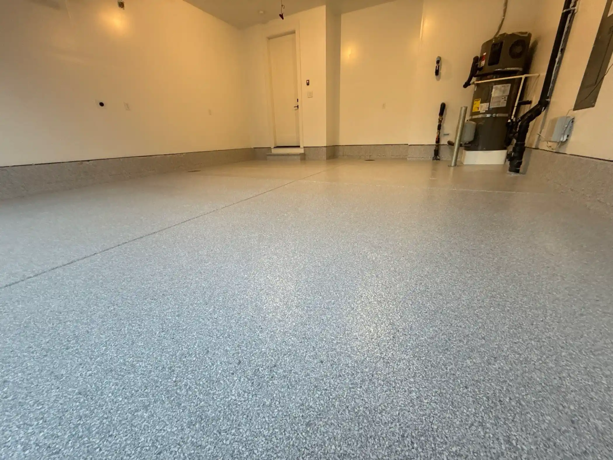 Light grey Ash flake floor and coated wall base in a Duvall garage