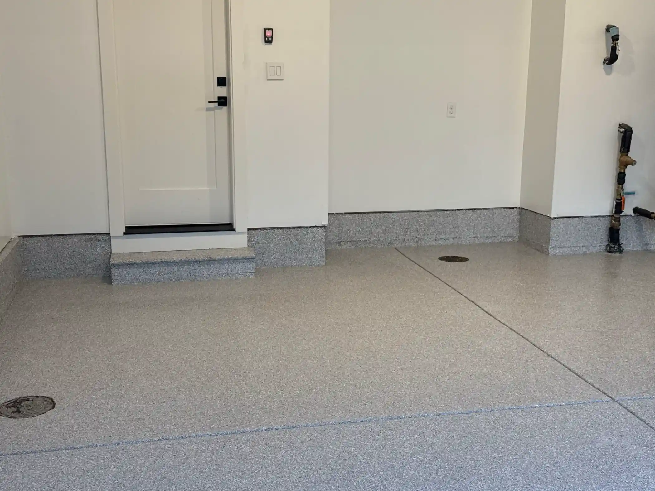 Coated entry step and stem wall in Ash flake in a Duvall garage