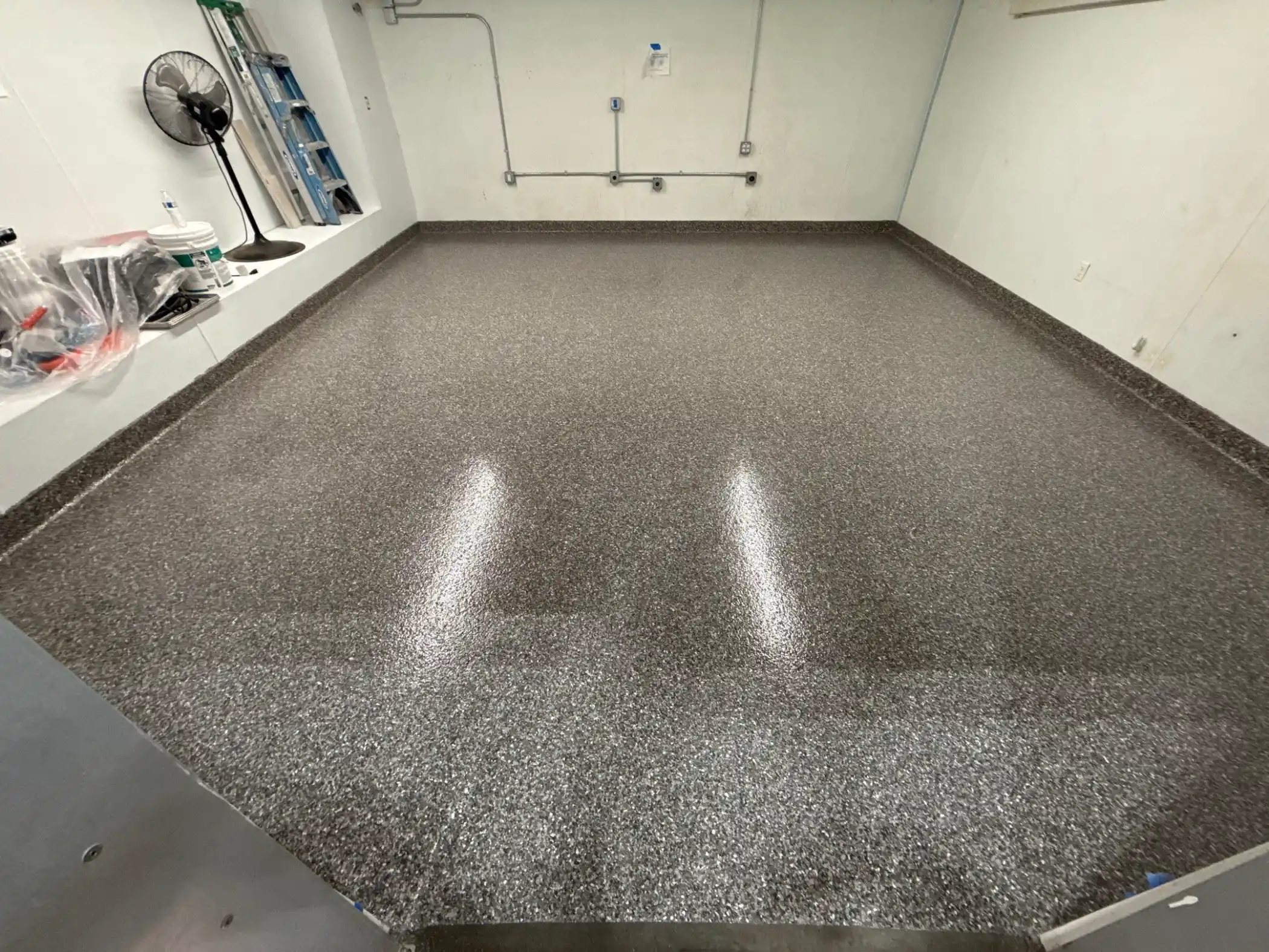 Silver Creek flake polyurea floor with cove base in a Seattle warehouse room