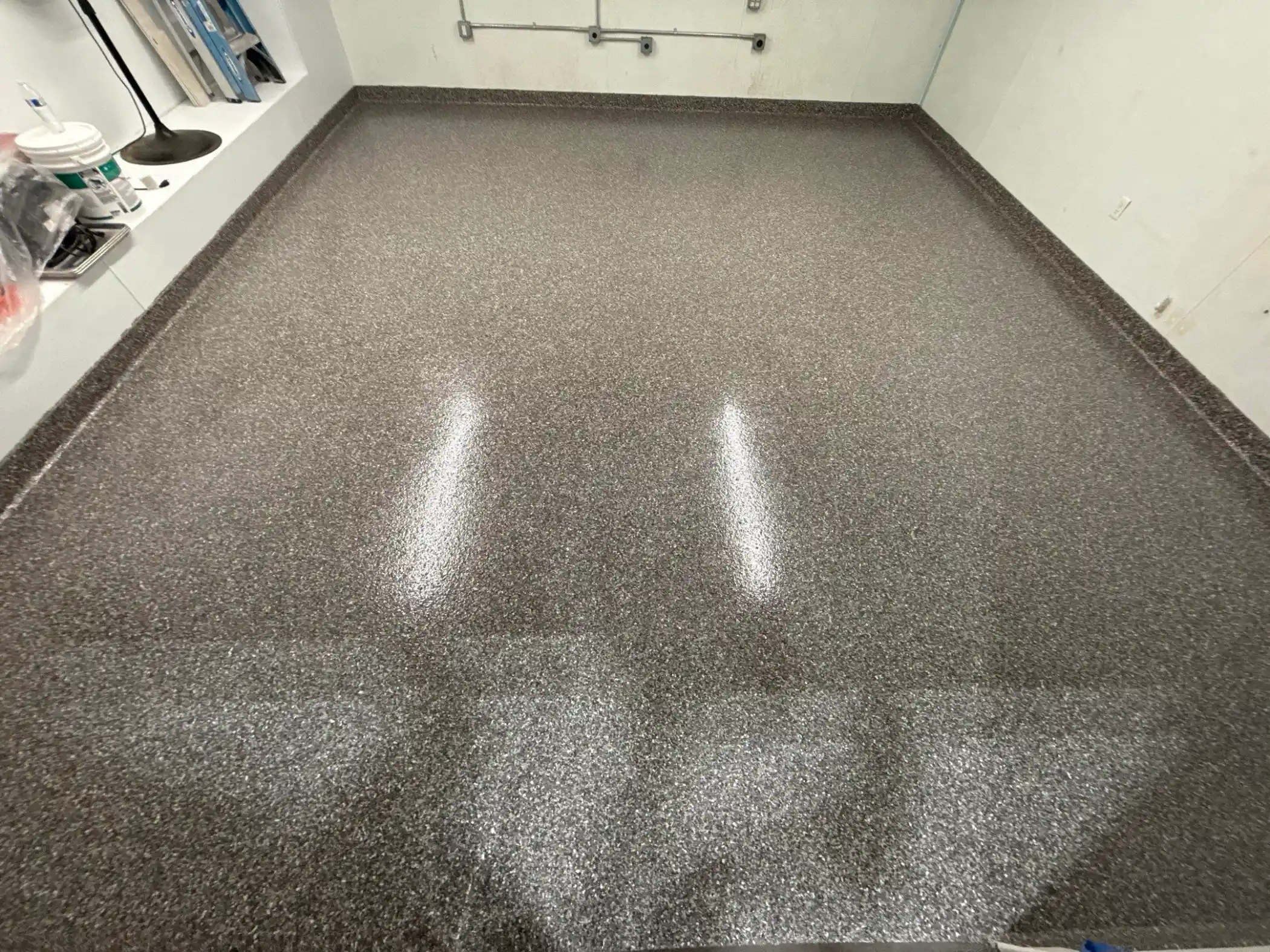 Silver Creek flake floor curving up into a cove base in a Seattle business