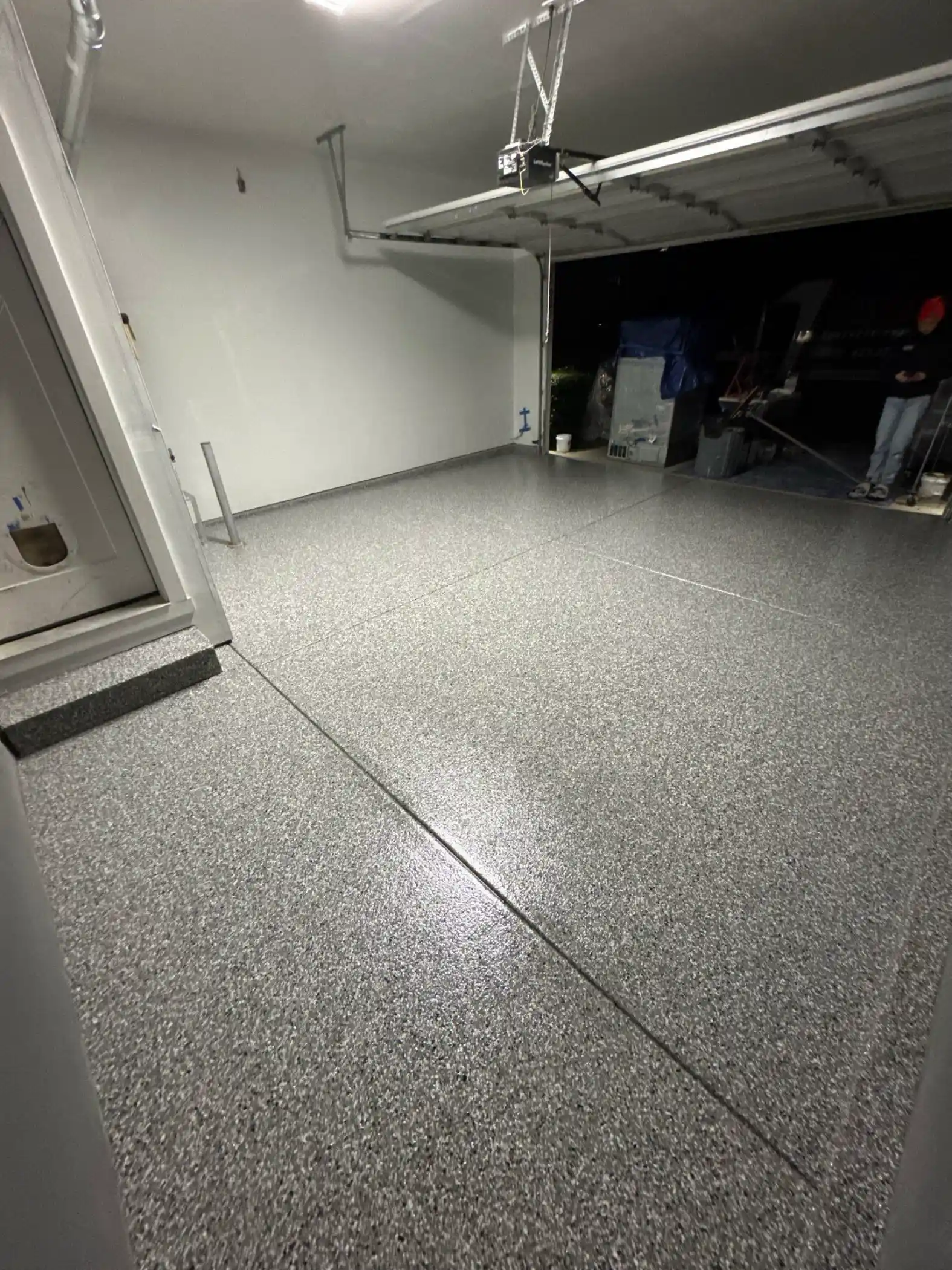 Smoke flake polyurea garage floor under an overhead storage rack in a Bothell home