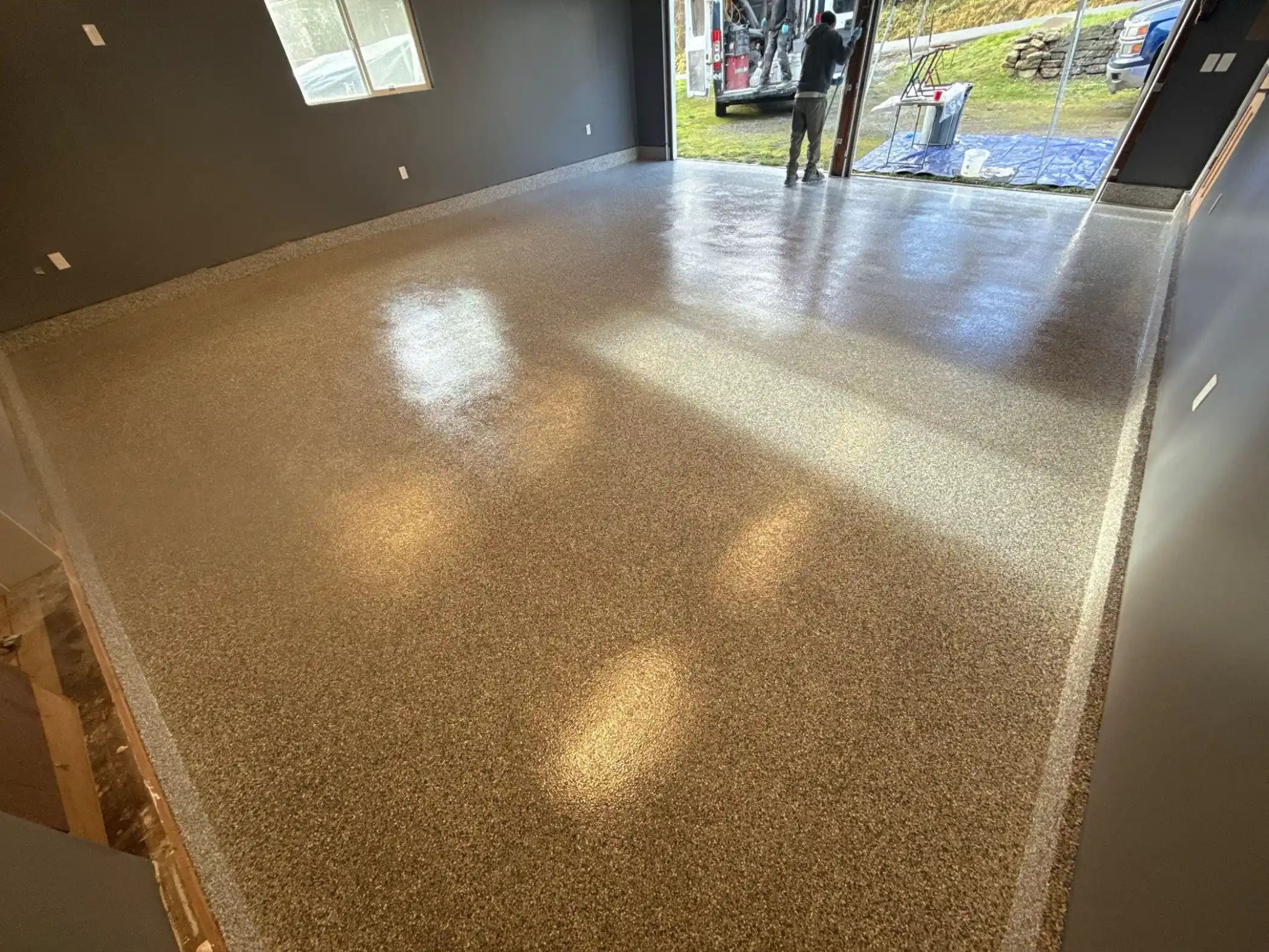 Open garage door and finished Slate Stone polyurea floor on Camano Island