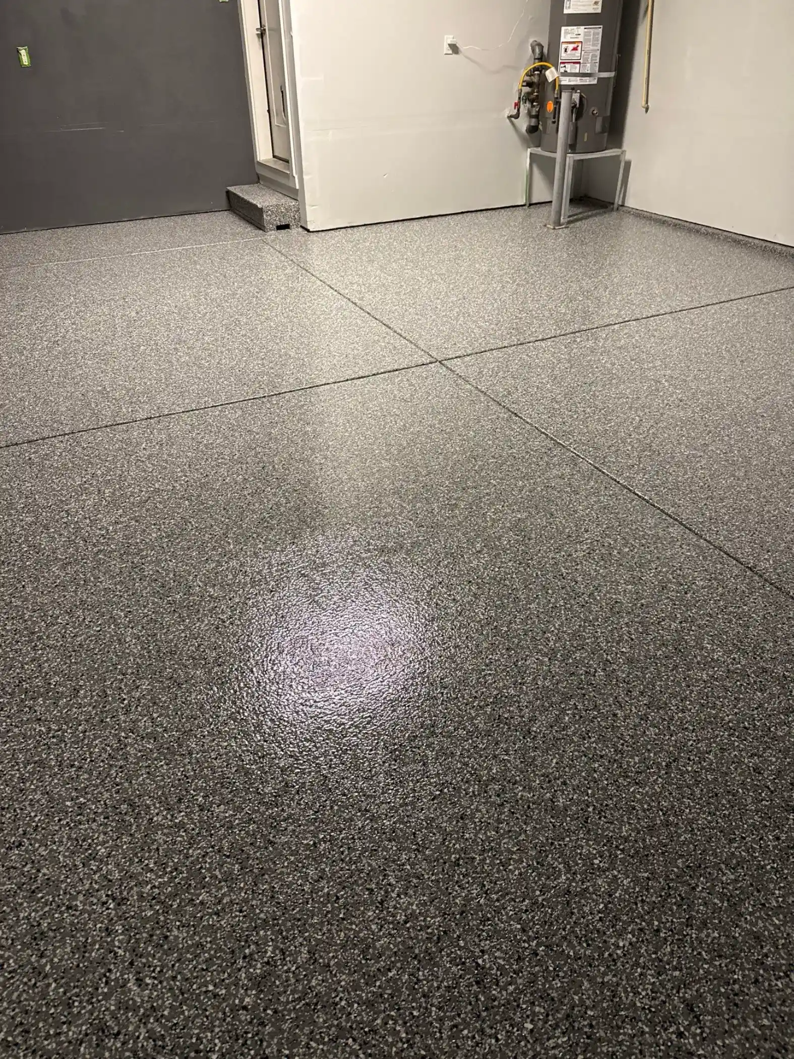 Smoke flake floor with control joints running toward the back wall of a Bothell garage