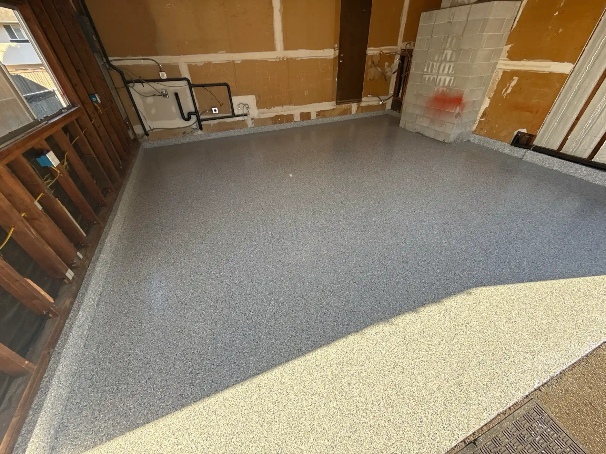 Tidal Wave flake polyurea floor in a Woodinville garage with open framed walls