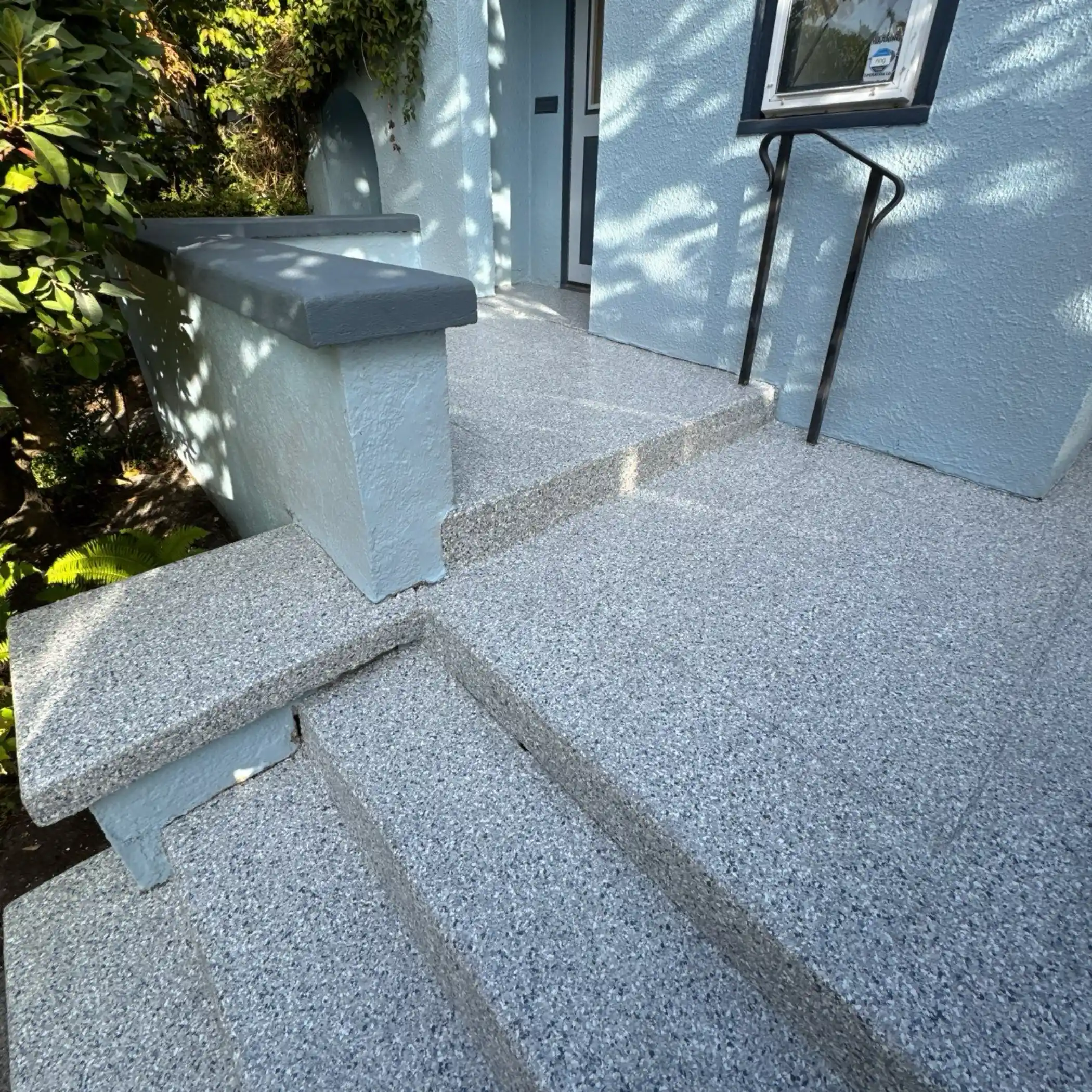 Tidal Wave flake front porch and steps at a blue stucco Seattle home