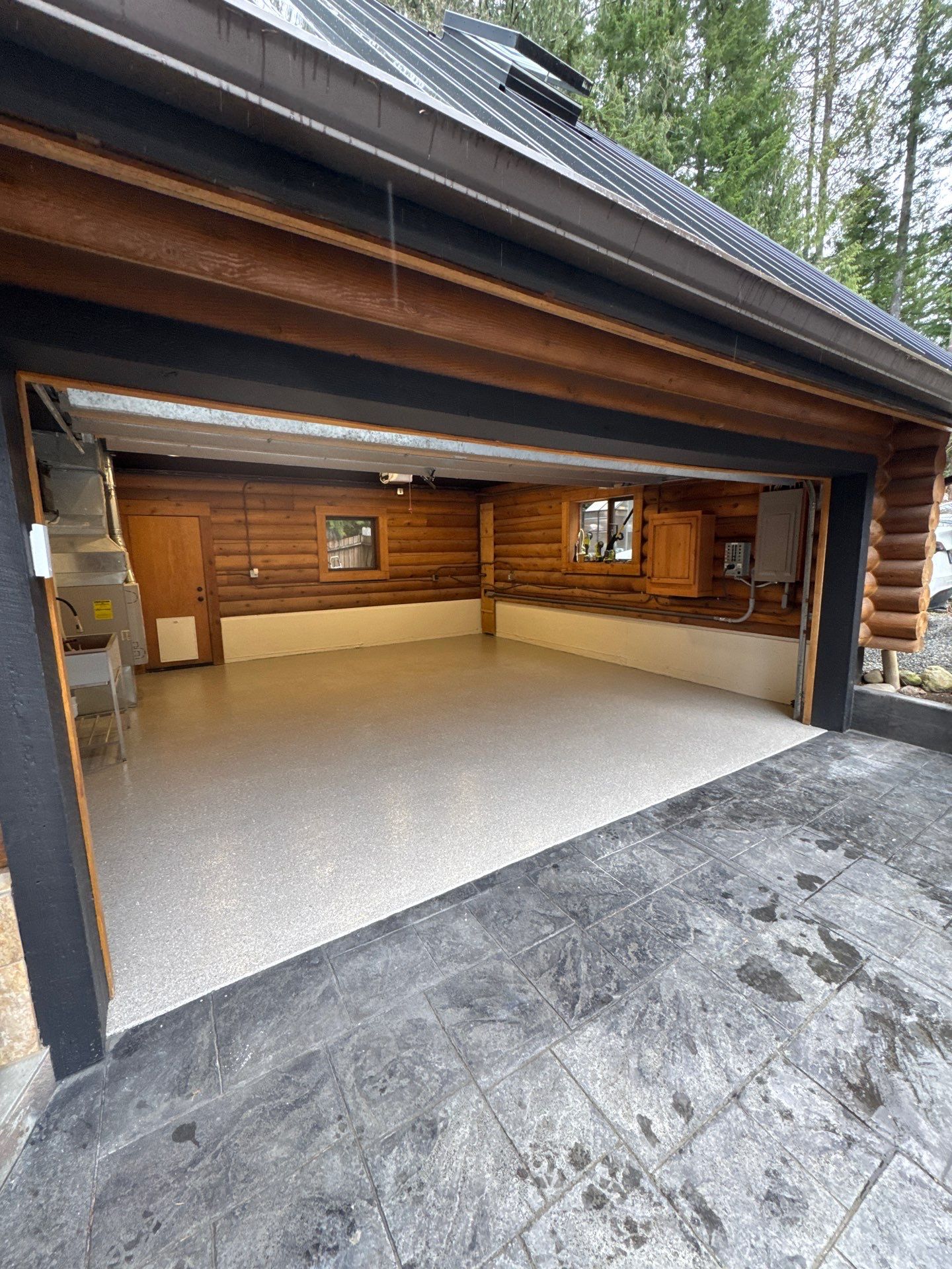 Log home garage in Fall City with a light Quartzite flake polyurea floor