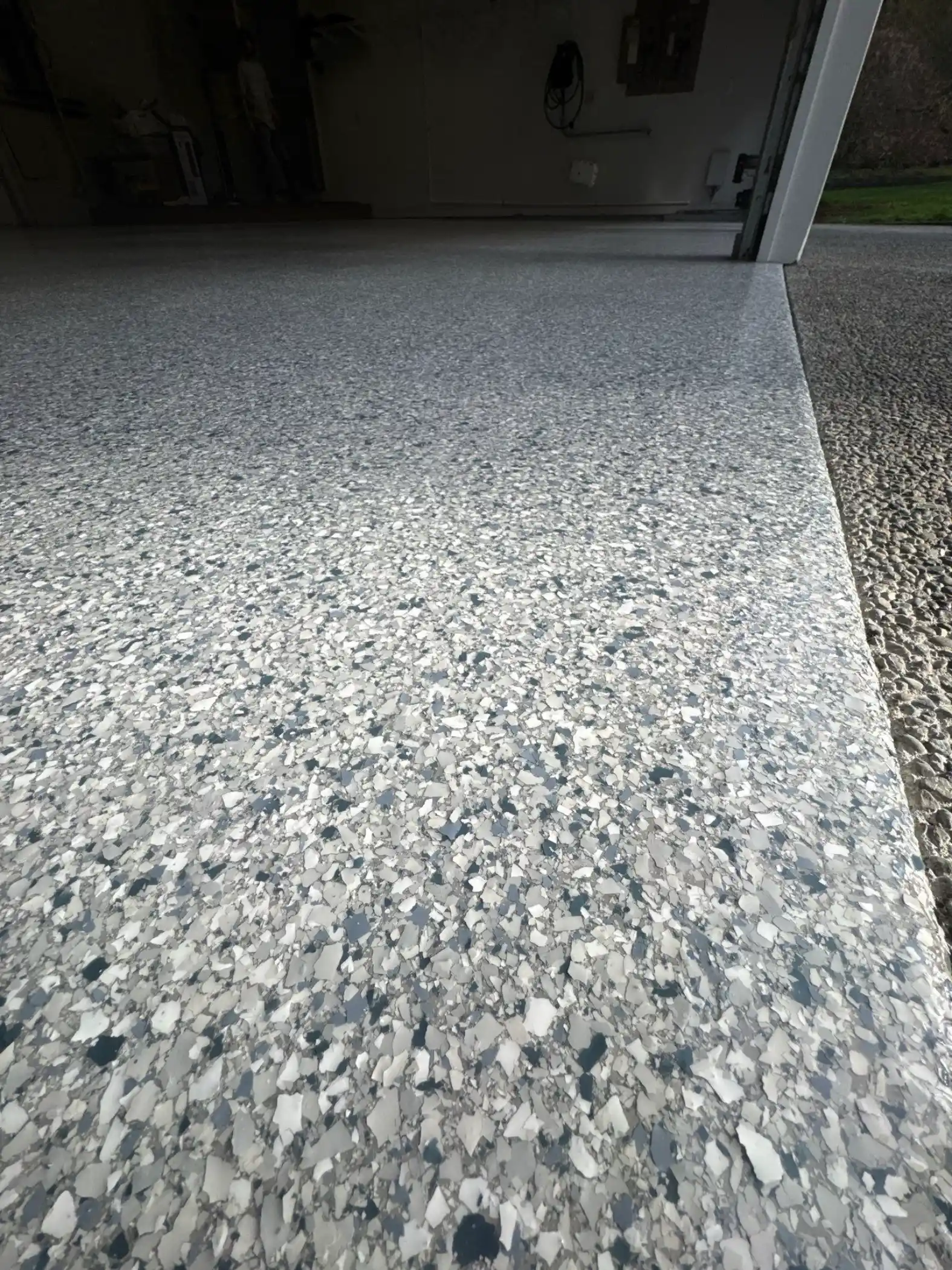 Close view of blue grey Tidal Wave flake at a Fox Island garage edge