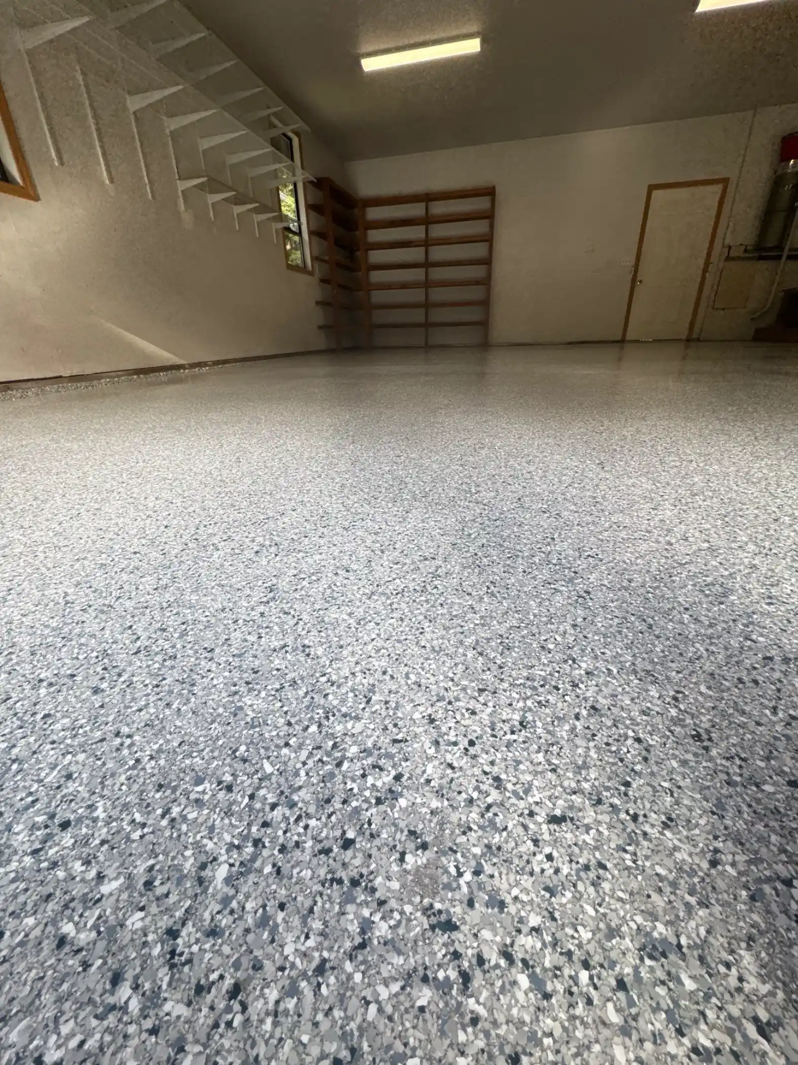 Tidal Wave flake floor below wood shelving in a Fox Island garage