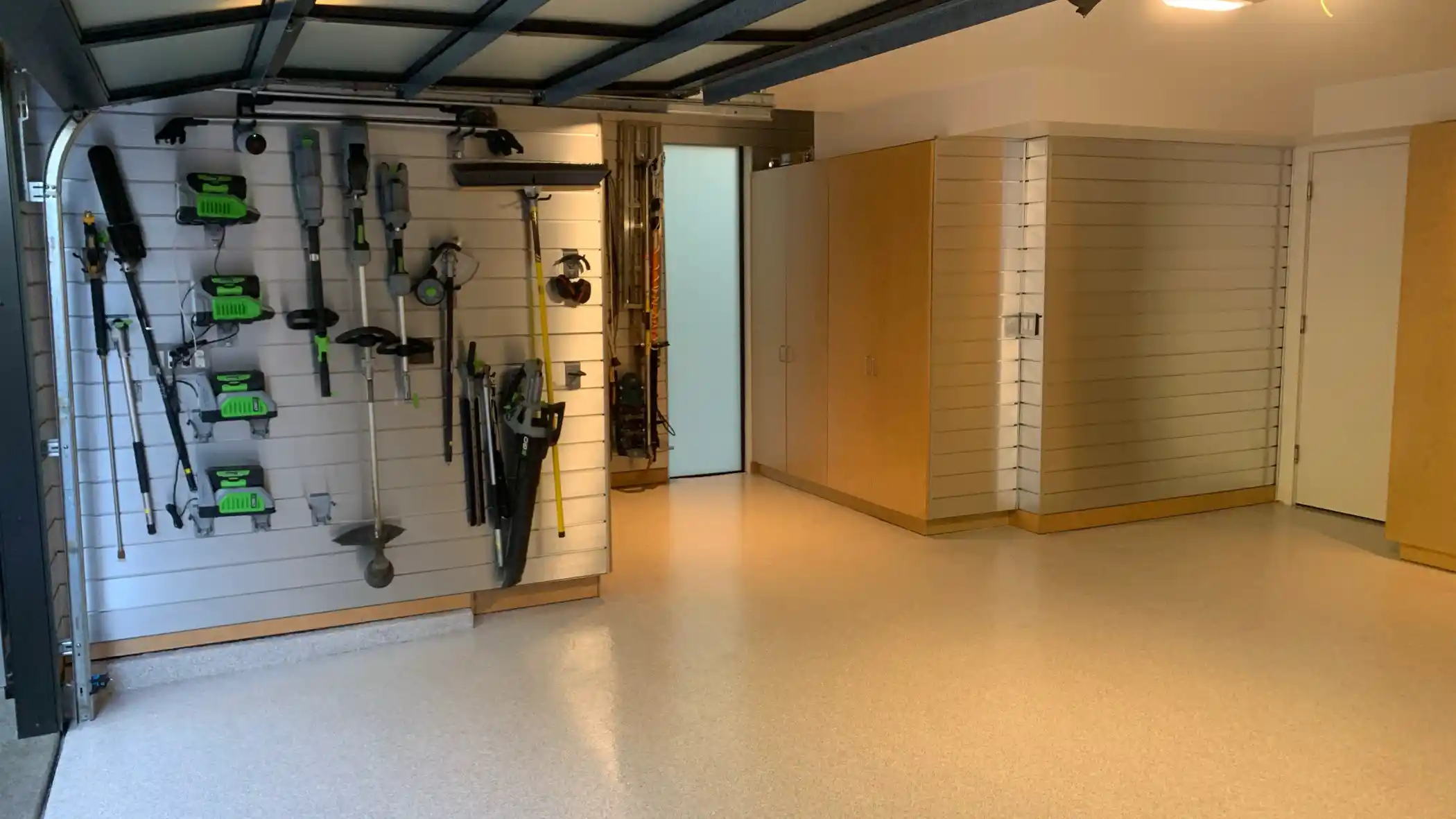 Slatwall tool storage above a light Limestone flake garage floor in Hunts Point