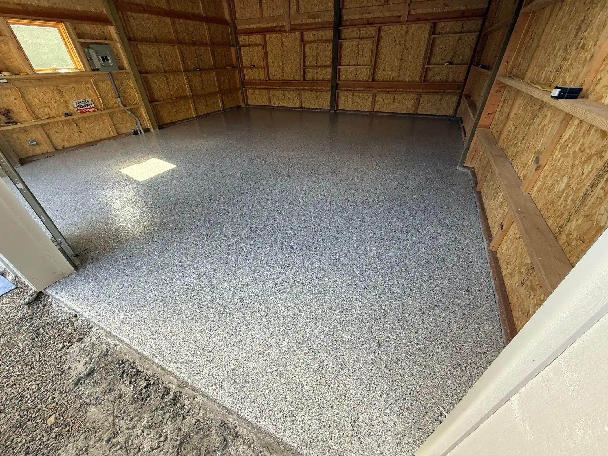 Tidal Wave flake polyurea floor in a new detached garage with OSB walls in Woodinville