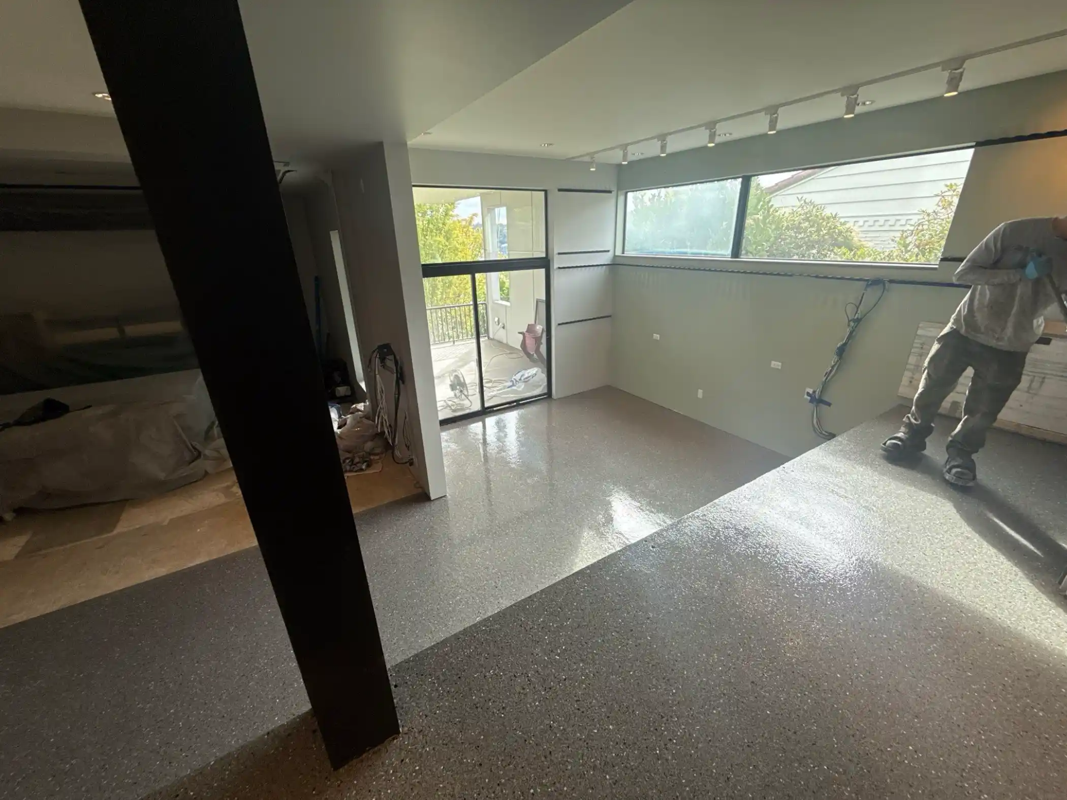 Crew member beside a new Slate flake basement floor in Seattle