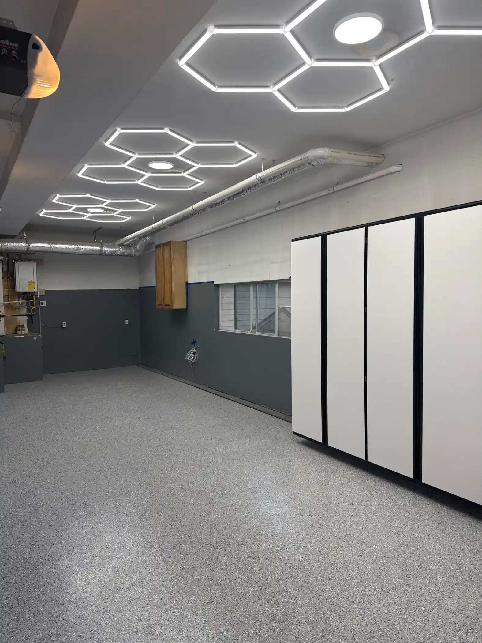 Tidal Wave flake garage floor under hexagon LED lights in an Everett home