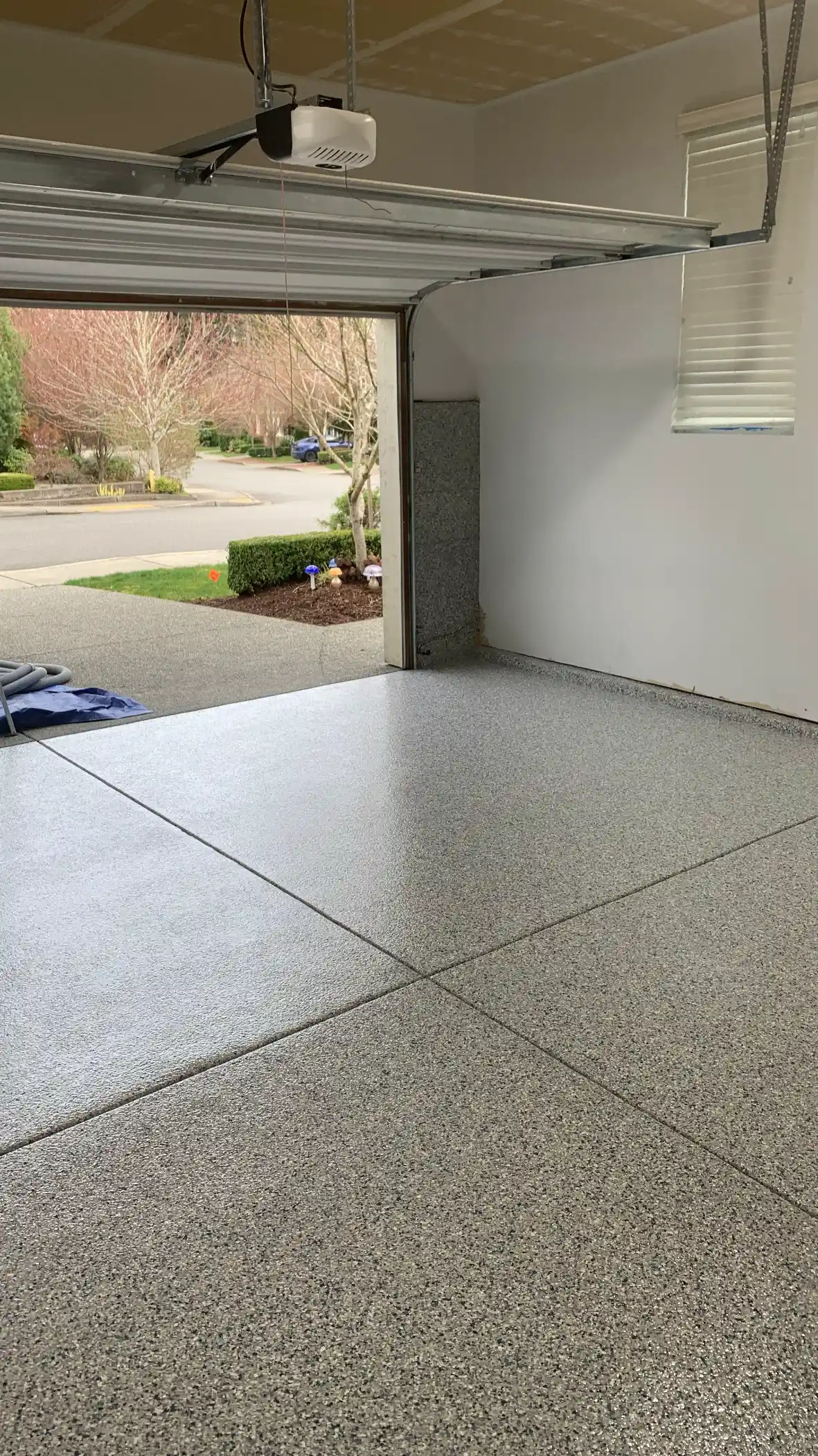 Tidal Wave flake polyurea garage floor in Sammamish with the door open to the street