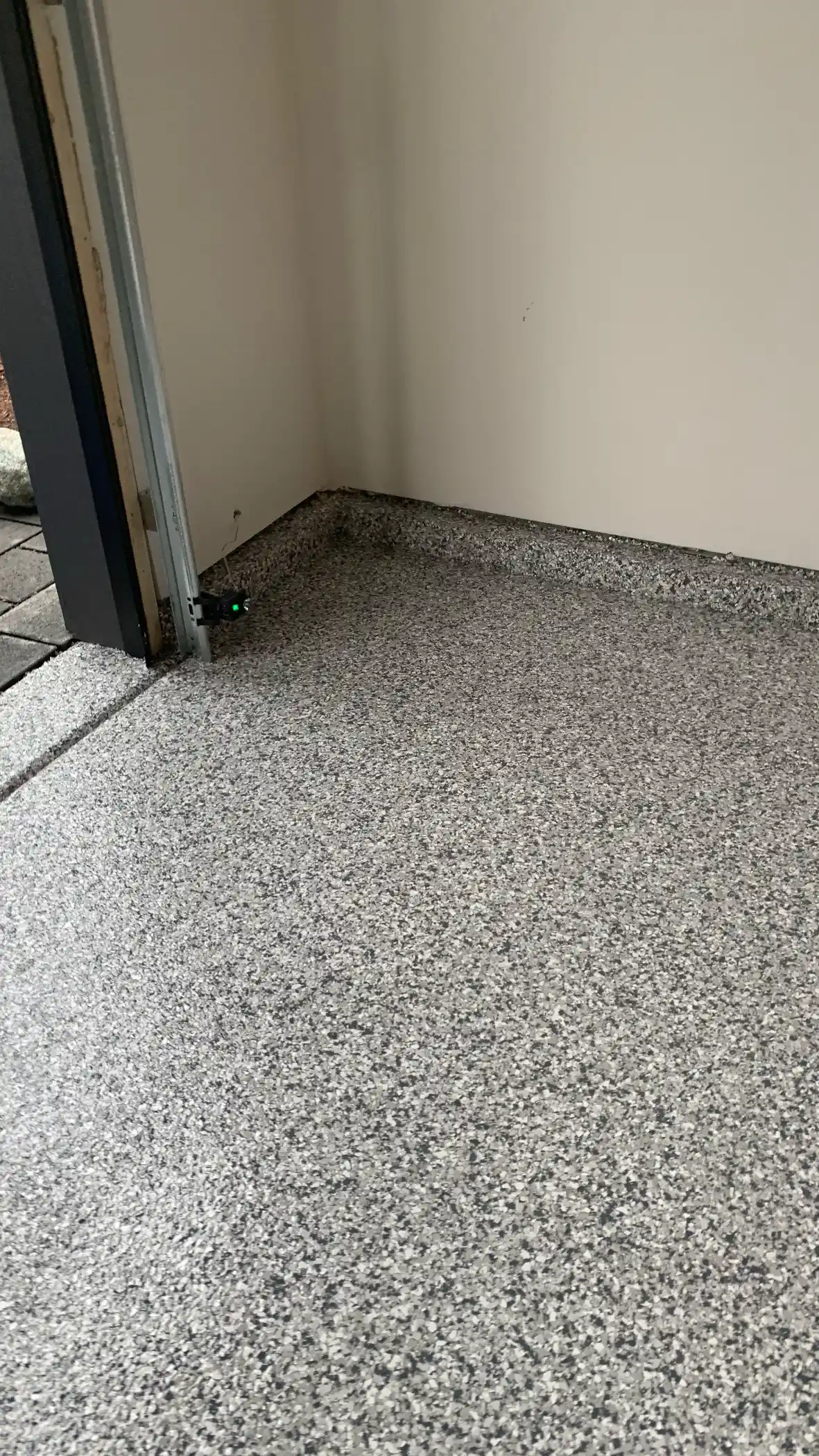 Slate Stone polyurea floor meeting the garage door frame in a Shoreline home