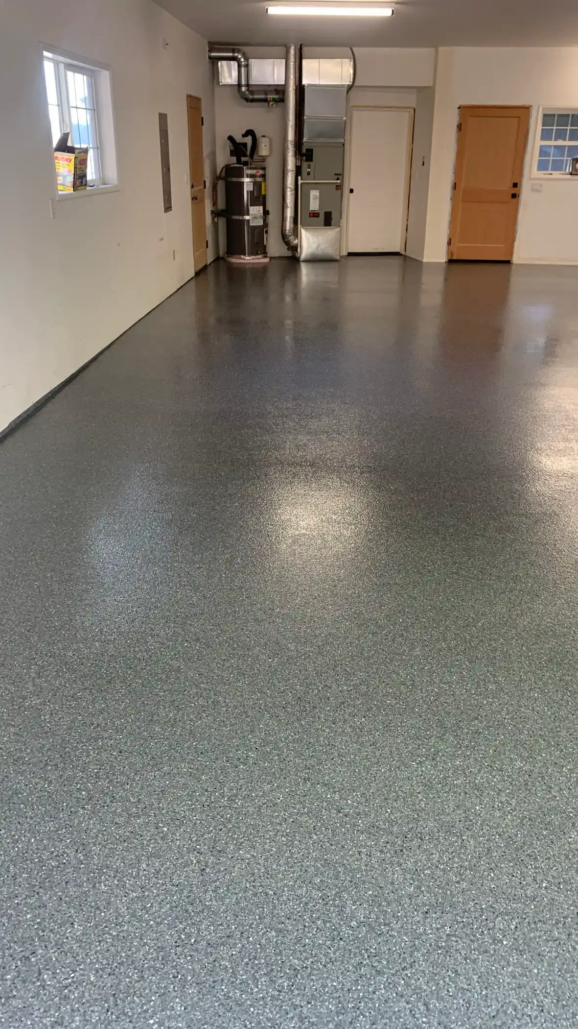 Long Belfair garage with a glossy Lani Grey flake polyurea floor