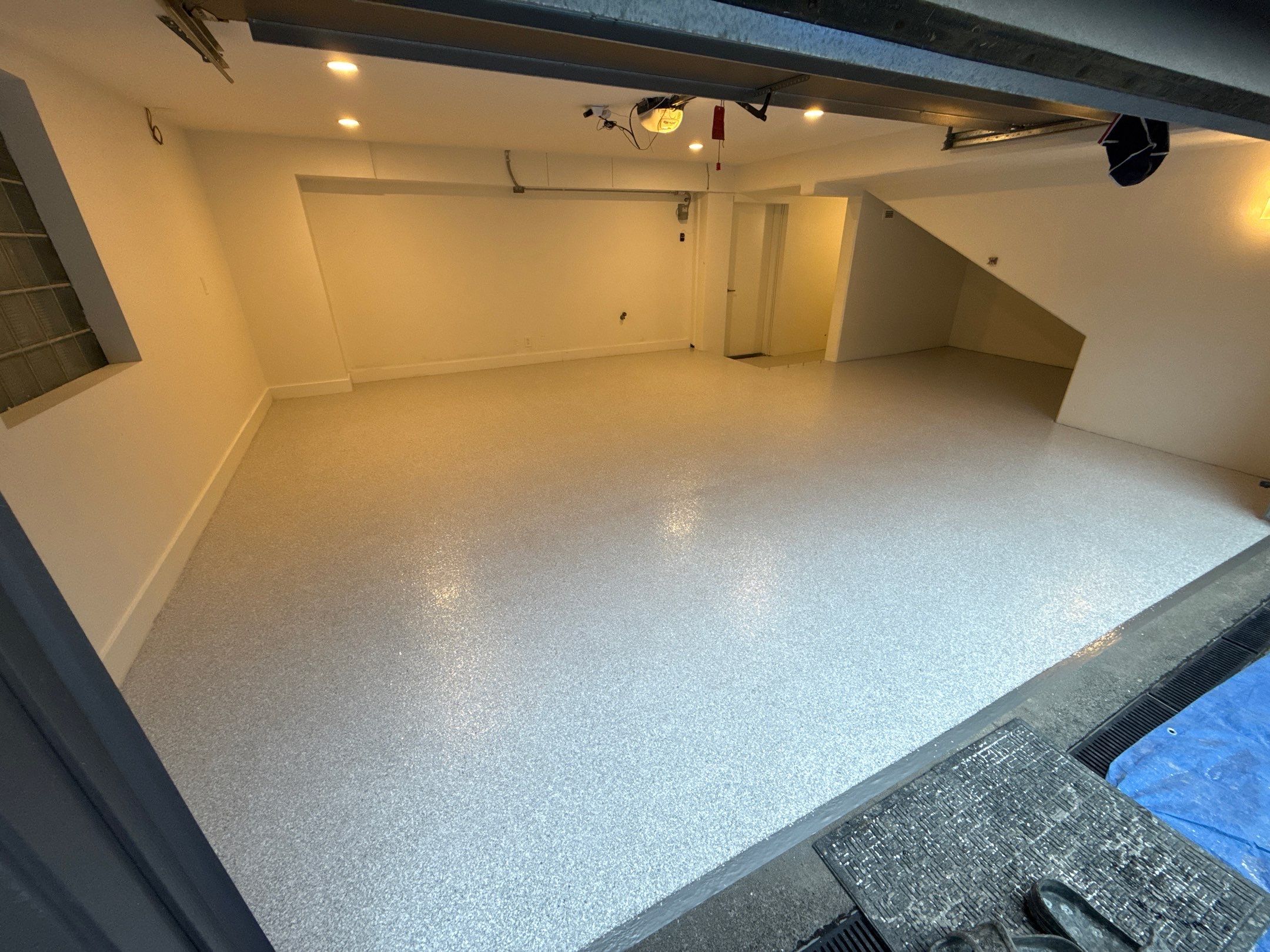 Bright Seattle garage with white walls and an Ash flake polyurea floor