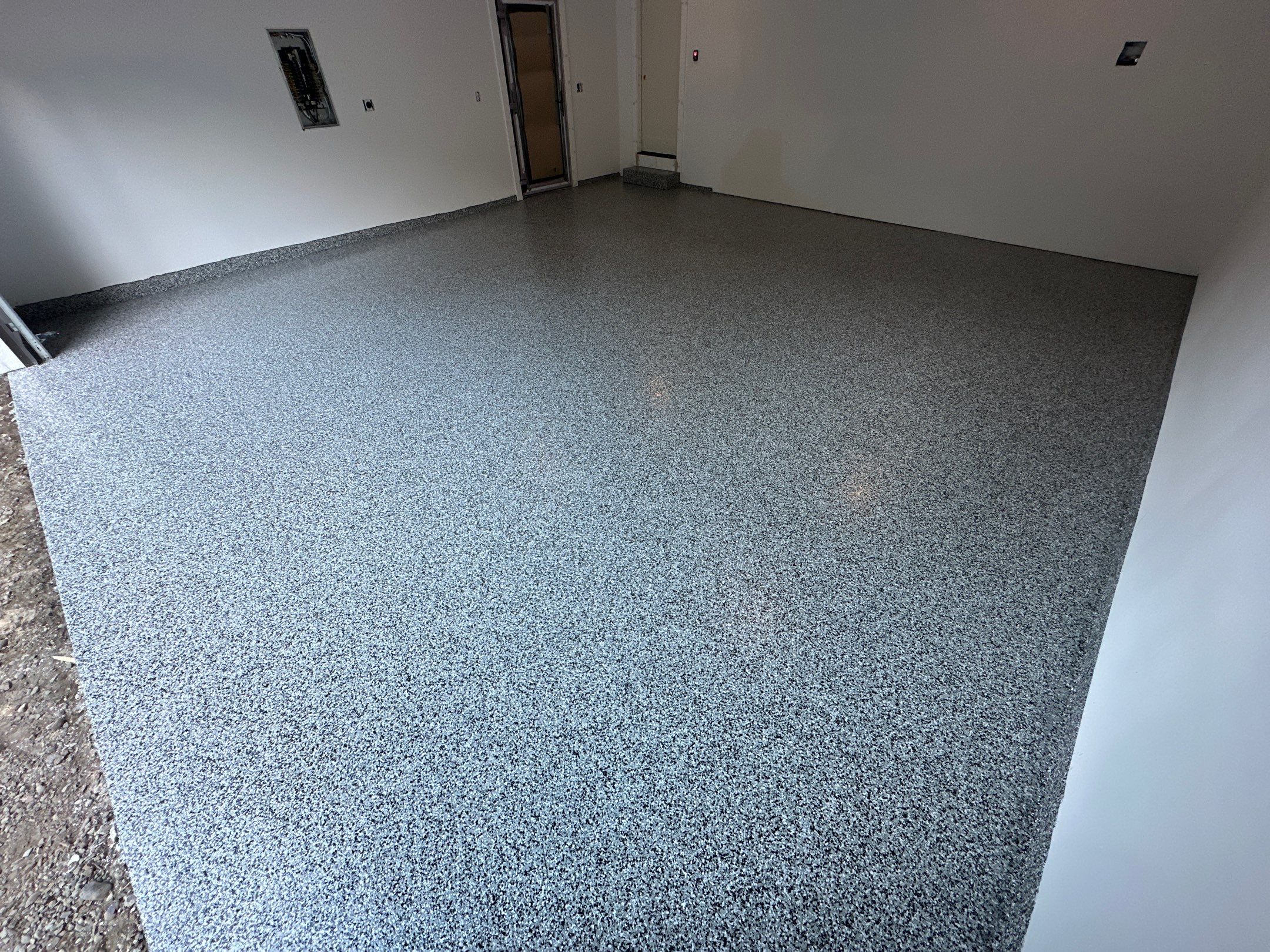 Domino flake polyurea floor in a new construction garage in Edgewood